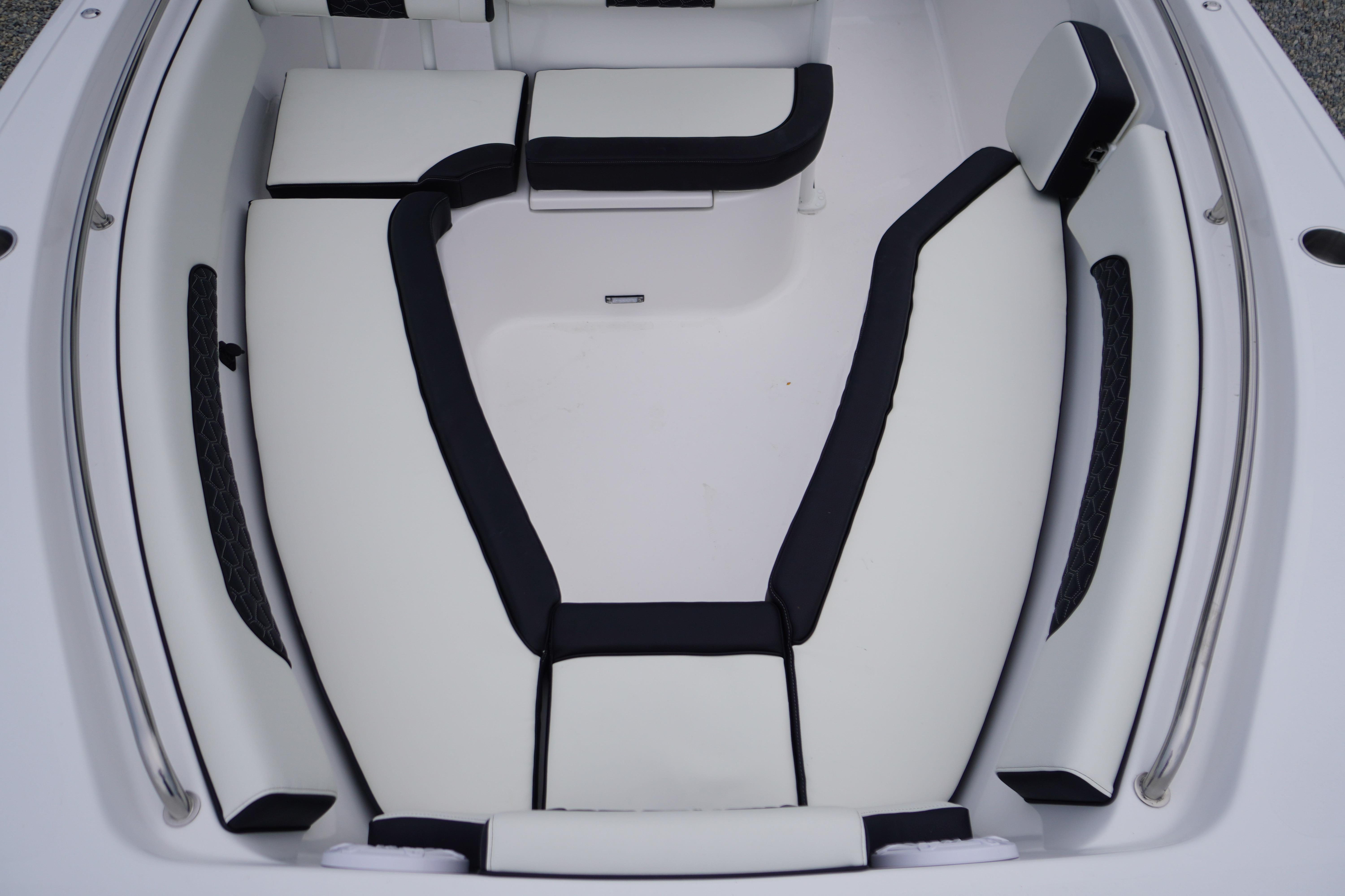 2026 Tidewater 232 SS boat interior with sleek white and black seating arrangement.