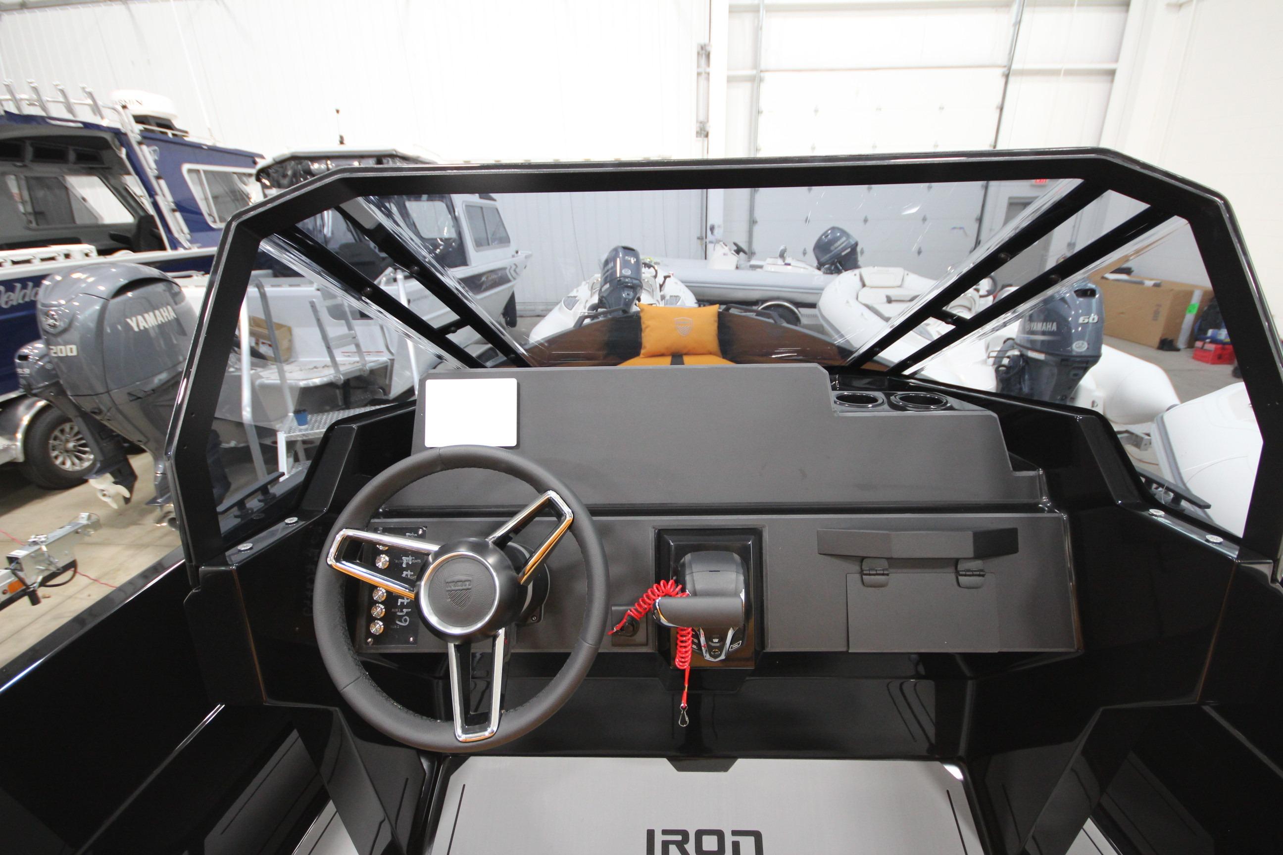 Interior view of Iron 767 boat dashboard, featuring steering wheel and controls, 2026 model.