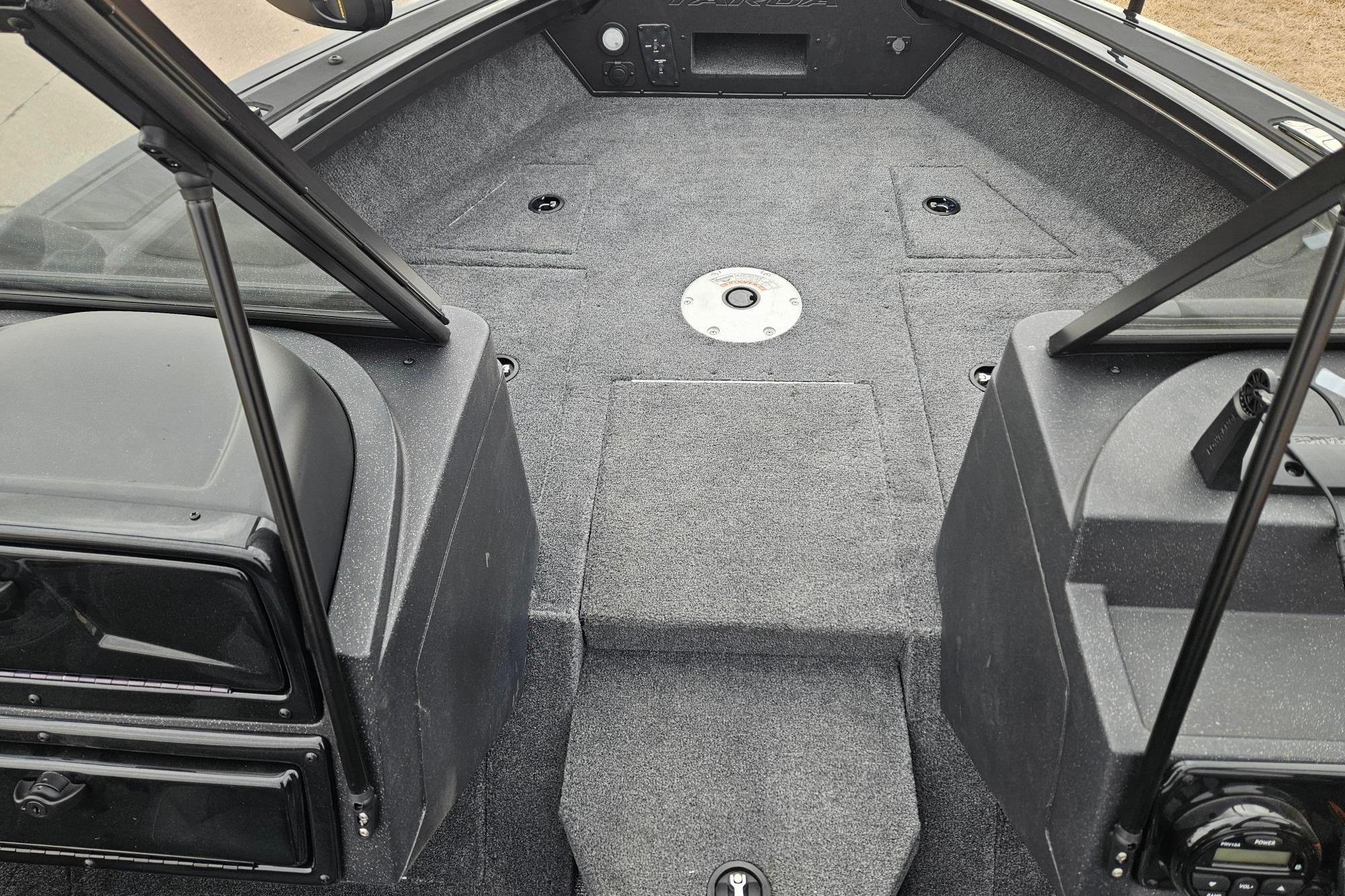 2026 Tracker Targa V-19 WT boat interior with carpeted deck and storage compartments.