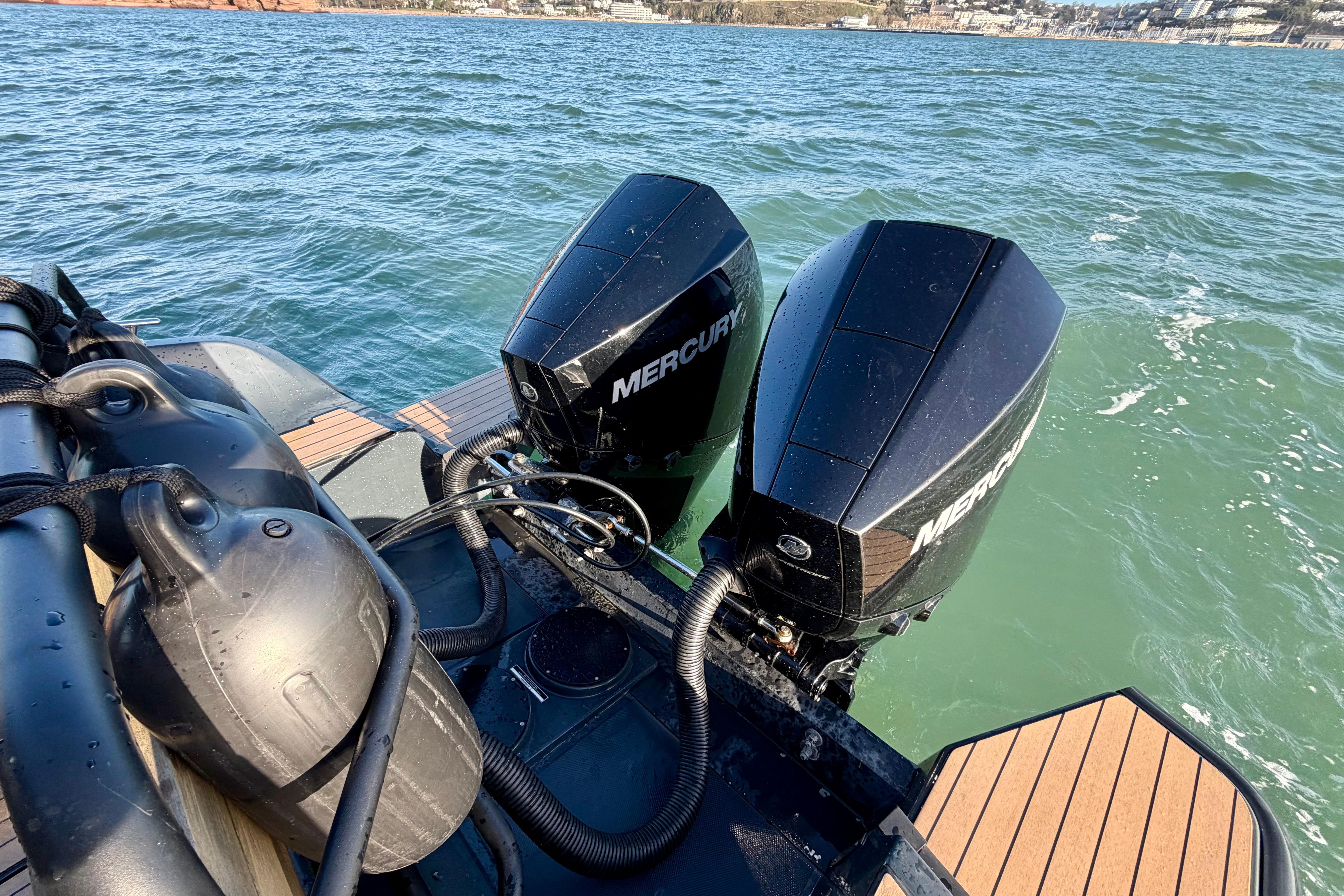 2022 XO EXPLR 10S boat with dual Mercury outboard engines on open water.
