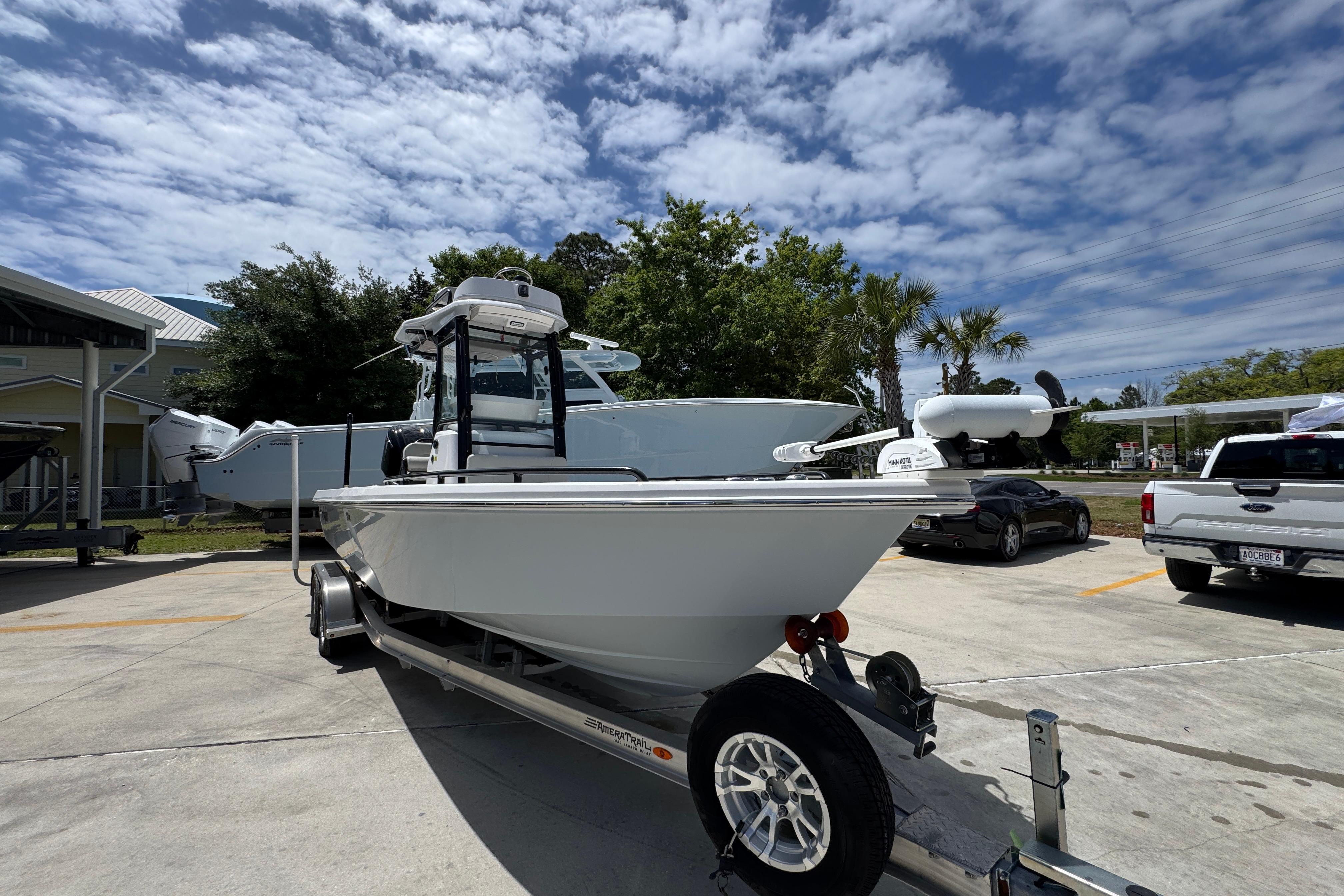 2022 Everglades 243 Center Console boat on trailer under a partly cloudy sky.