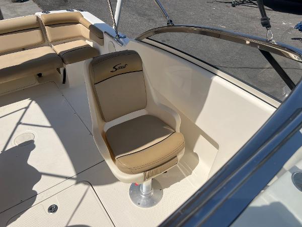 2019 Scout 210 Dorado boat interior with beige seating and steering chair.