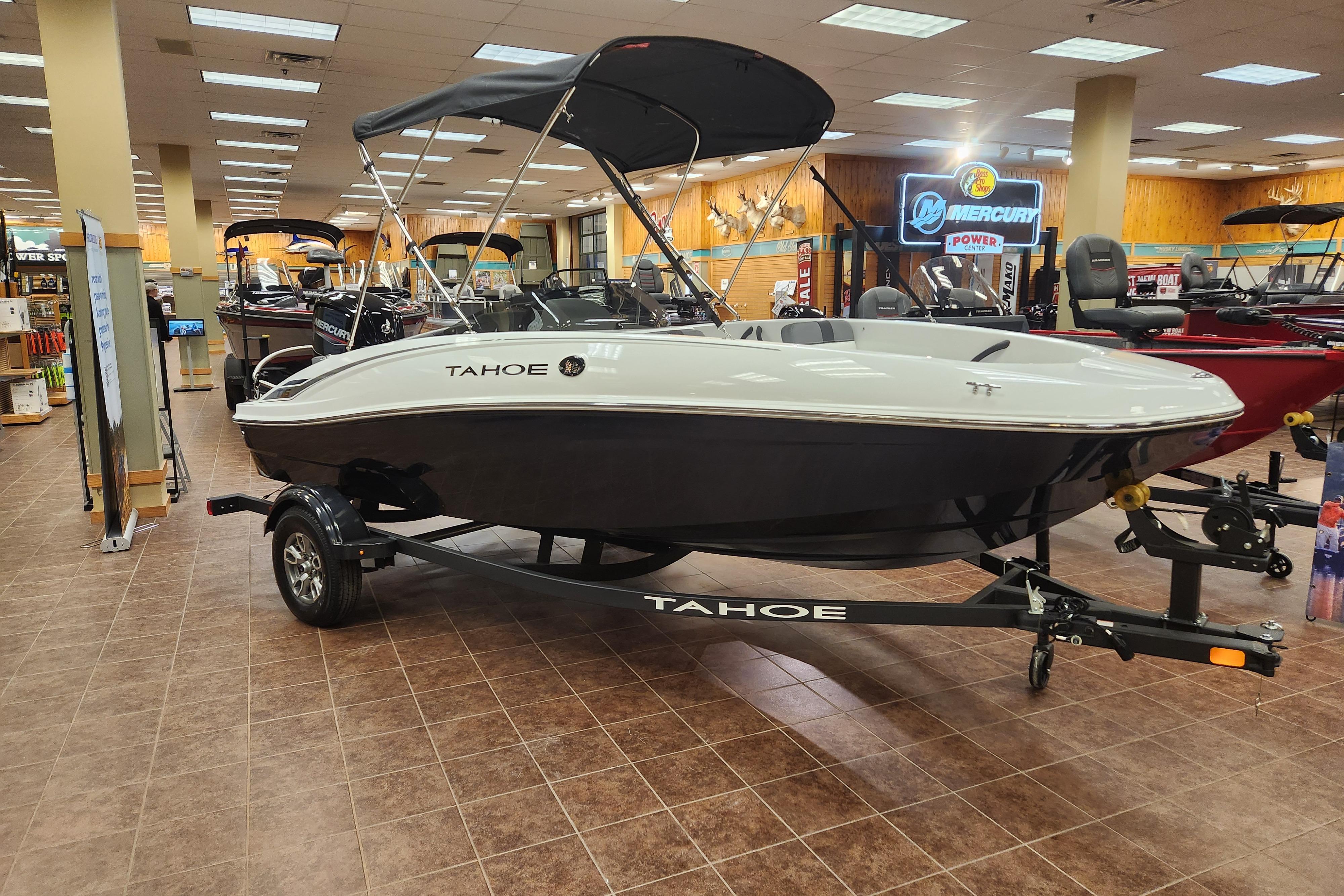 2026 Tahoe T16 boat displayed indoors on a trailer in a showroom.