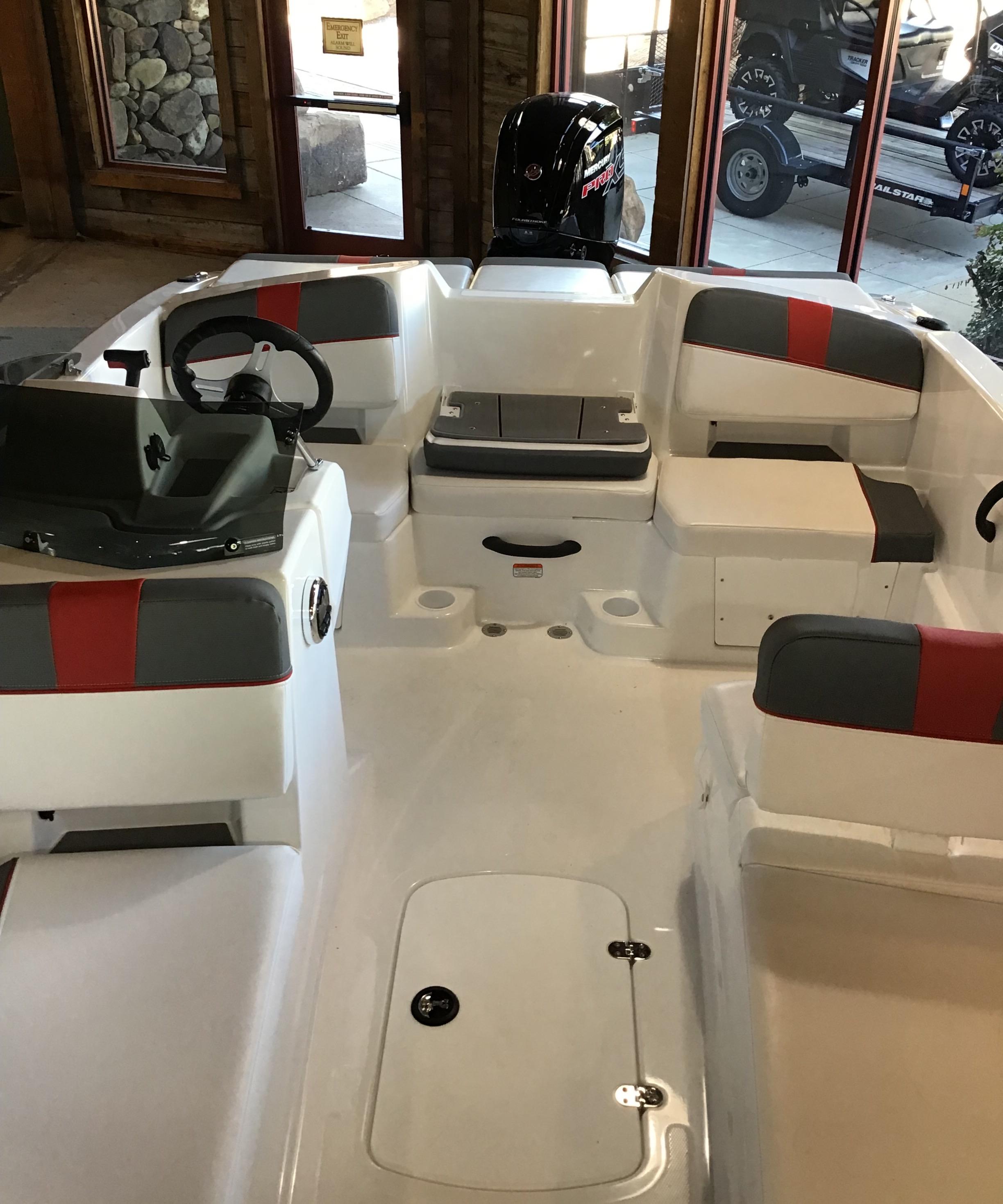 2025 Tahoe T18 boat interior with seating and steering wheel, displayed indoors.