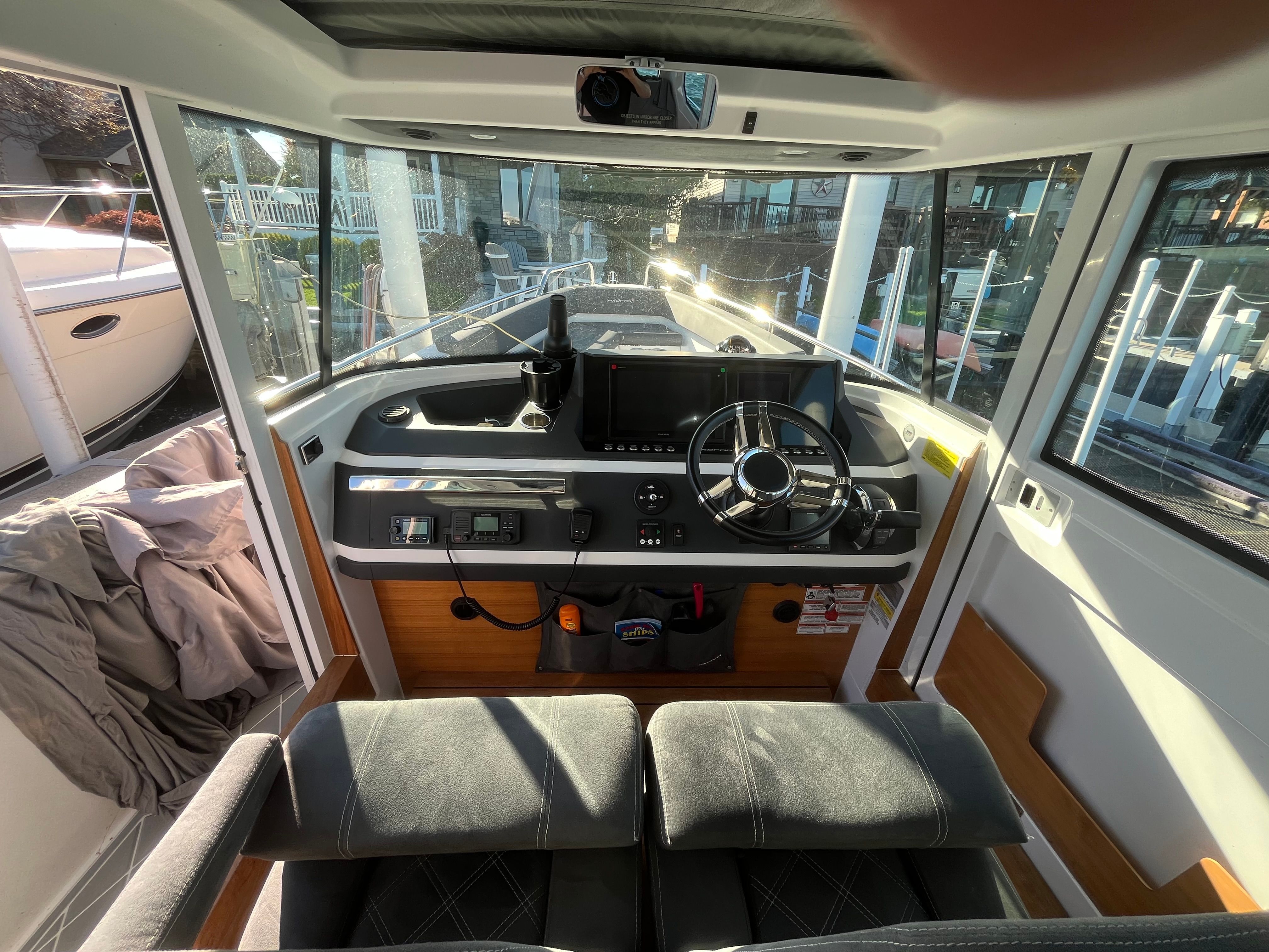 Interior view of the 2018 Axopar 28 Cabin with modern helm and comfortable seating.