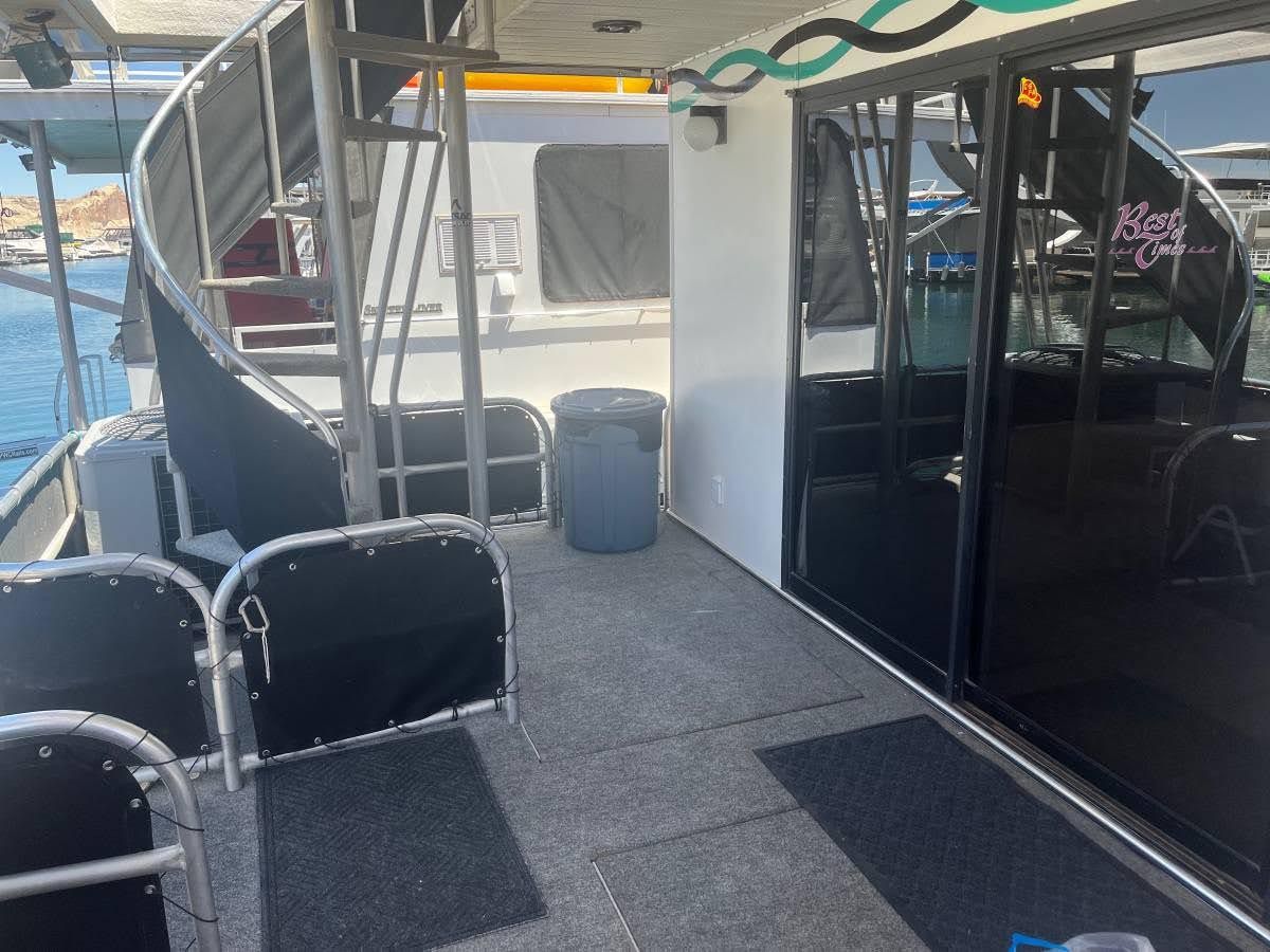 Deck of a 1993 Lakeview houseboat with spiral staircase.