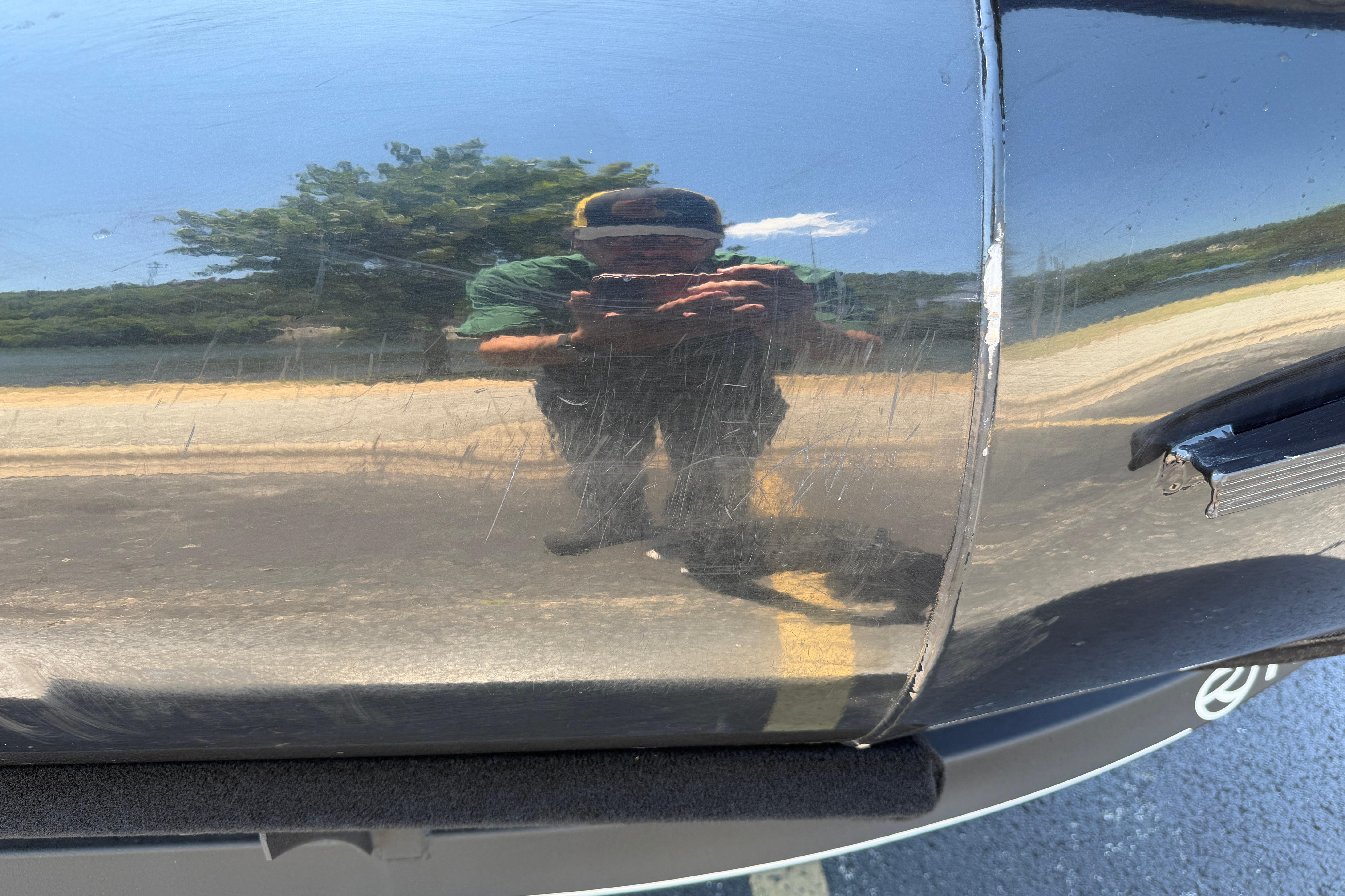 Reflection on 2024 Regency R250DL3 boat hull with visible scratches.