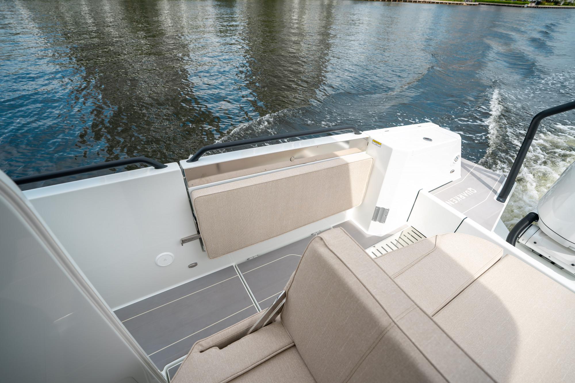 2025 Quarken 35 Sport Tourer boat interior with beige seating, on calm water.