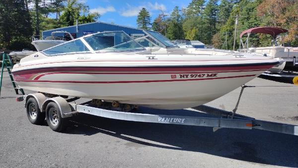 1999 Chaparral 2130 SS boat on trailer, parked outdoors with trees in background.