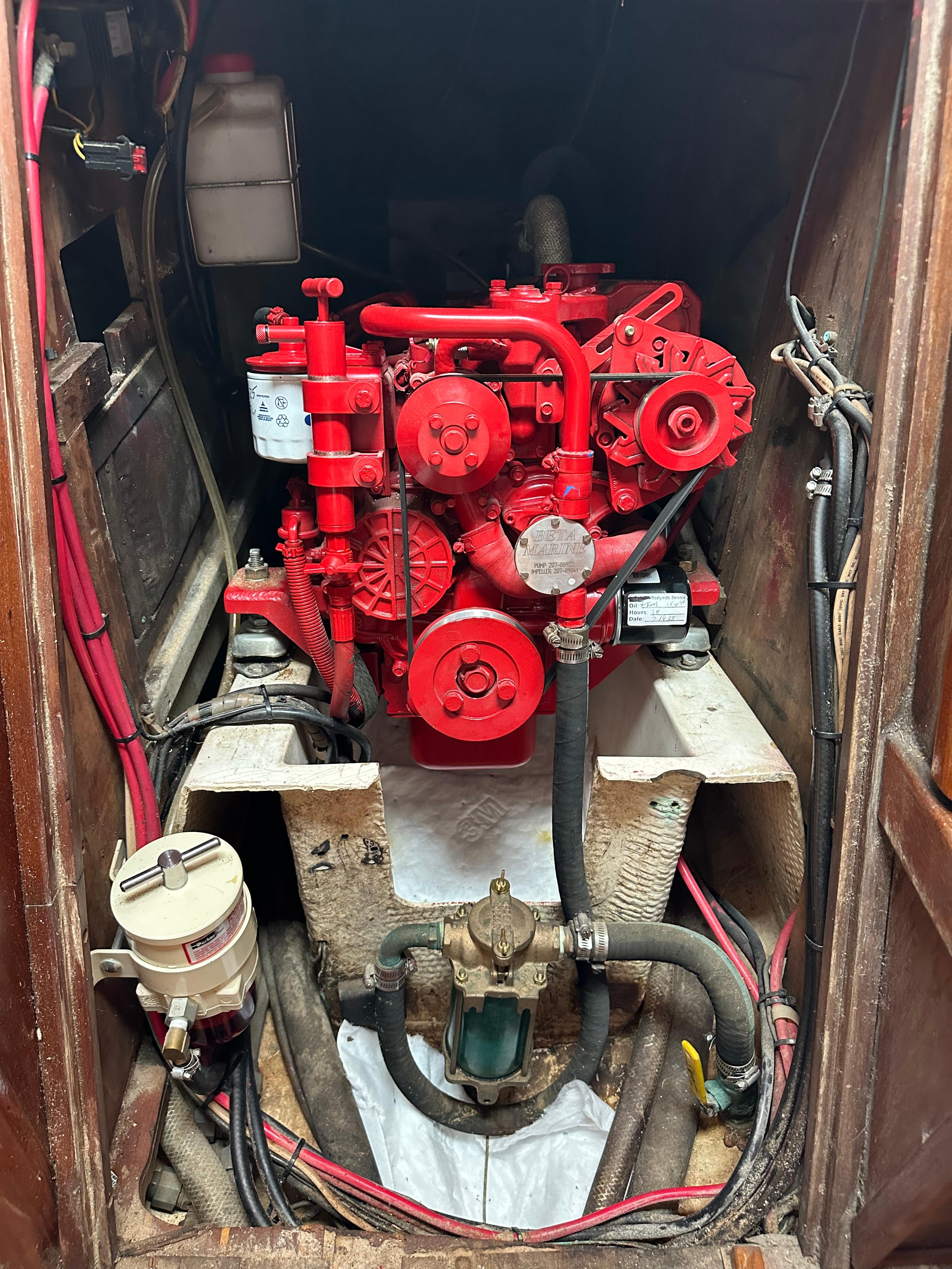 Engine compartment of a 1981 Tartan 37 sloop, featuring a red marine engine.