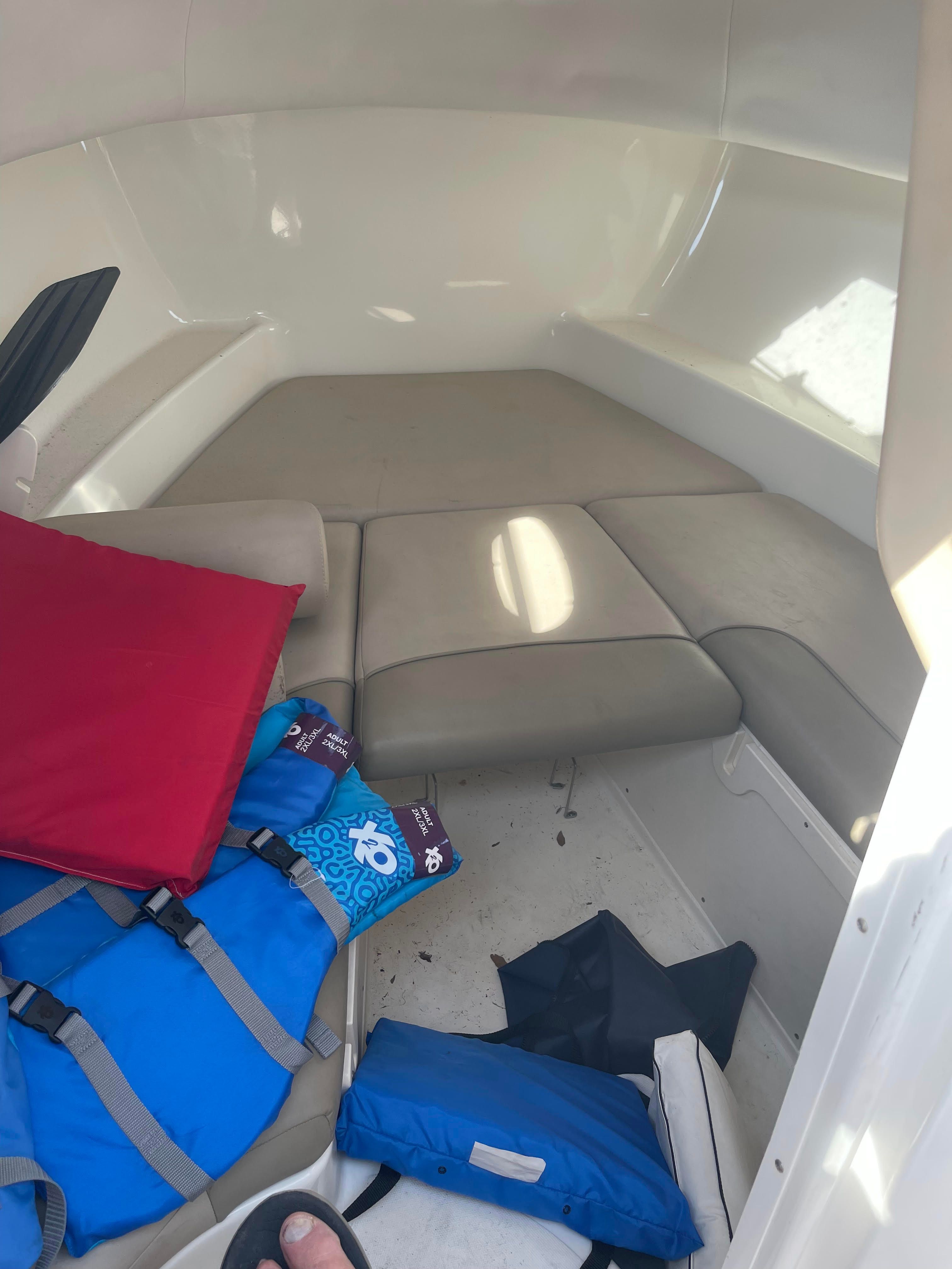 Interior of 2010 Boston Whaler 235 Conquest with cushions and life jackets.