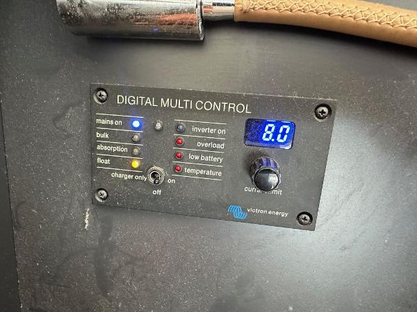 Digital multi control panel with various indicators and a display reading 8.0, Victron Energy.