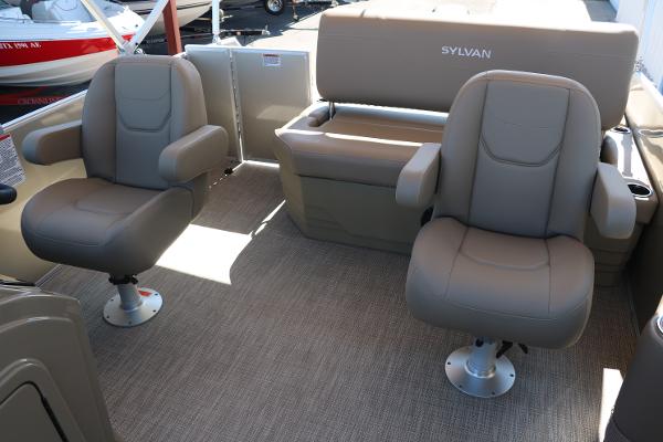 2025 Sylvan Mirage 820 CLZ DH boat interior with beige seating and carpet.