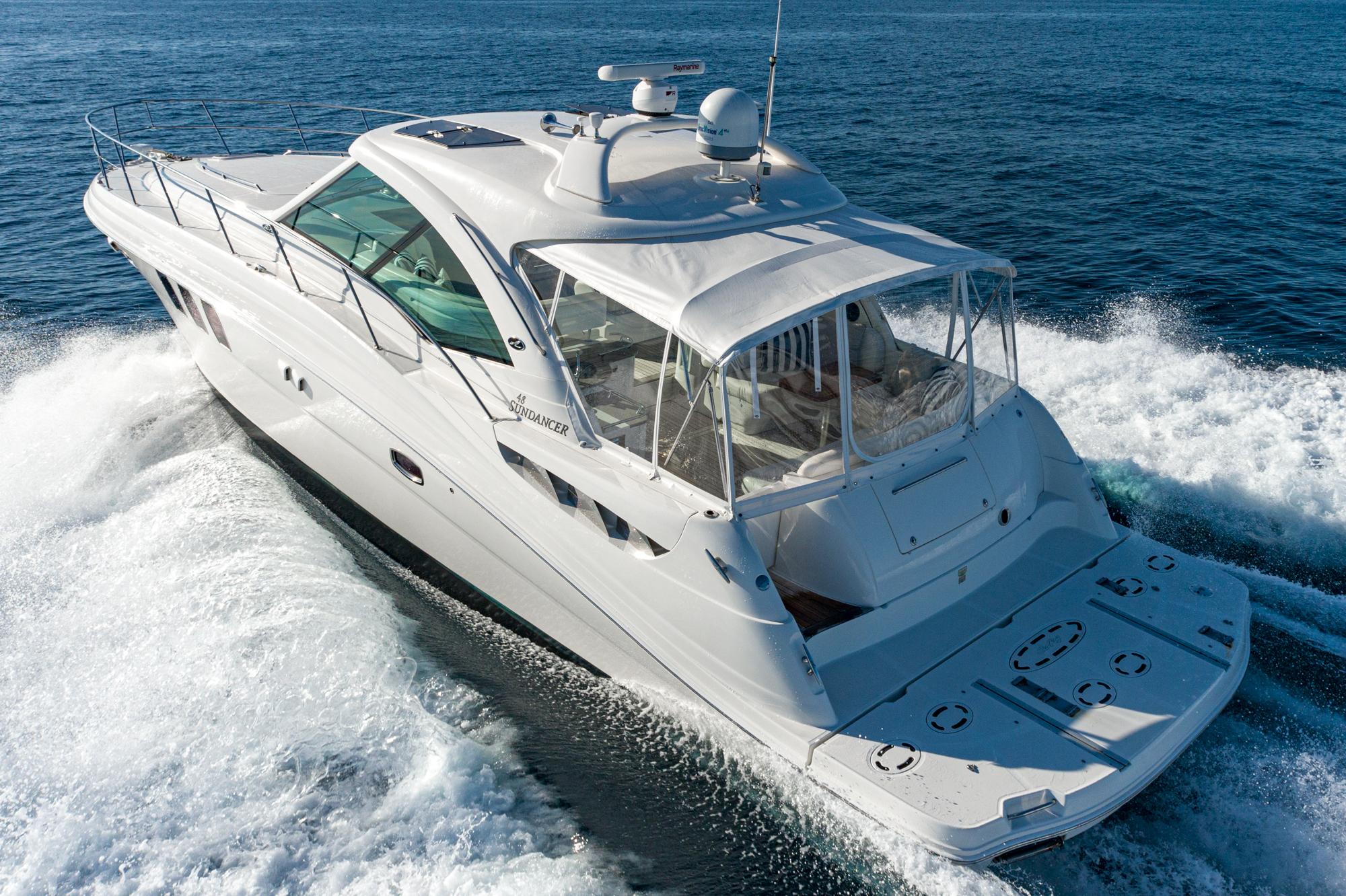 2005 Sea Ray 480 Sundancer yacht cruising on open sea.