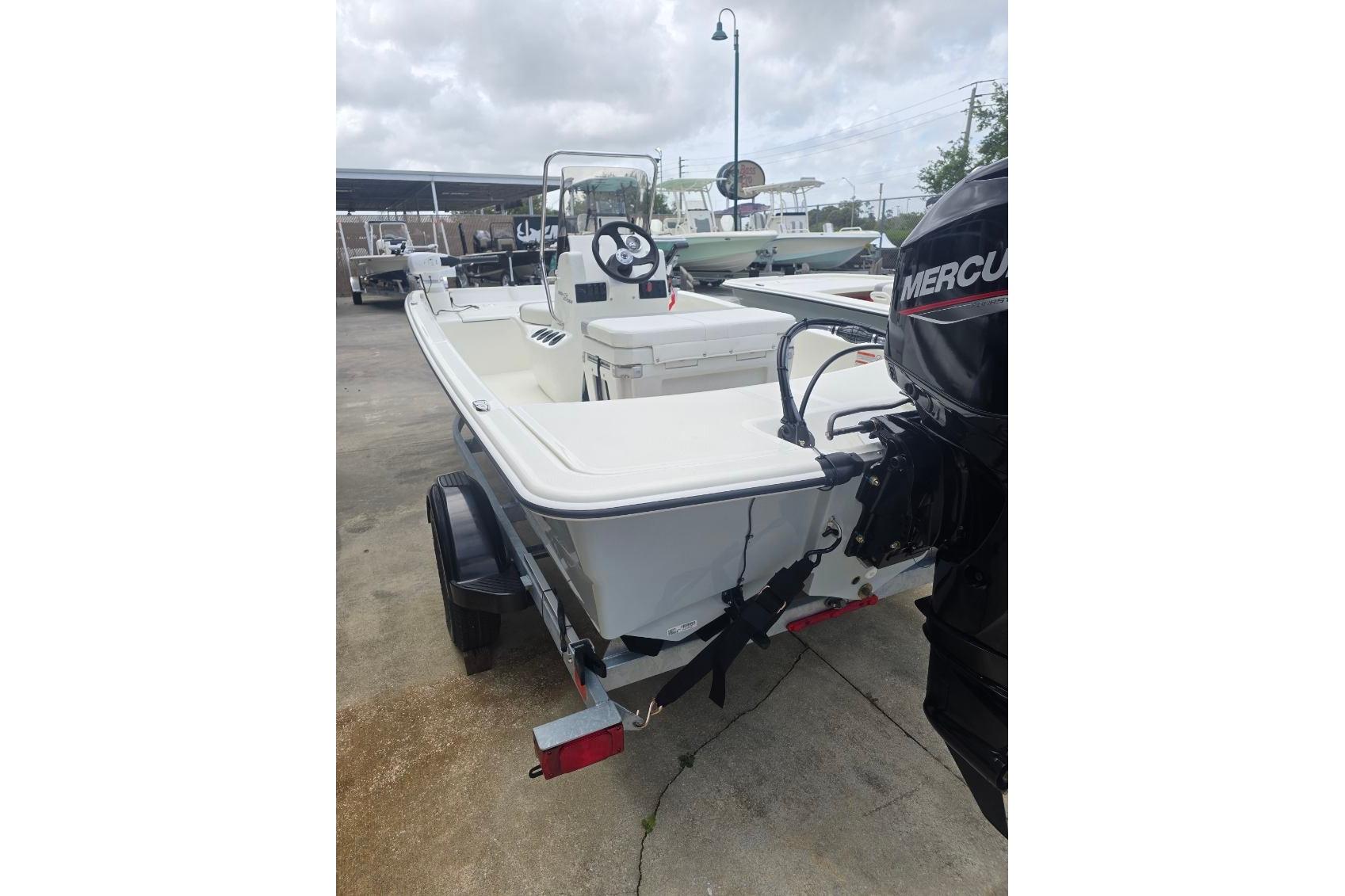 2026 Mako Pro Skiff 15 CC boat with Mercury outboard motor on trailer.