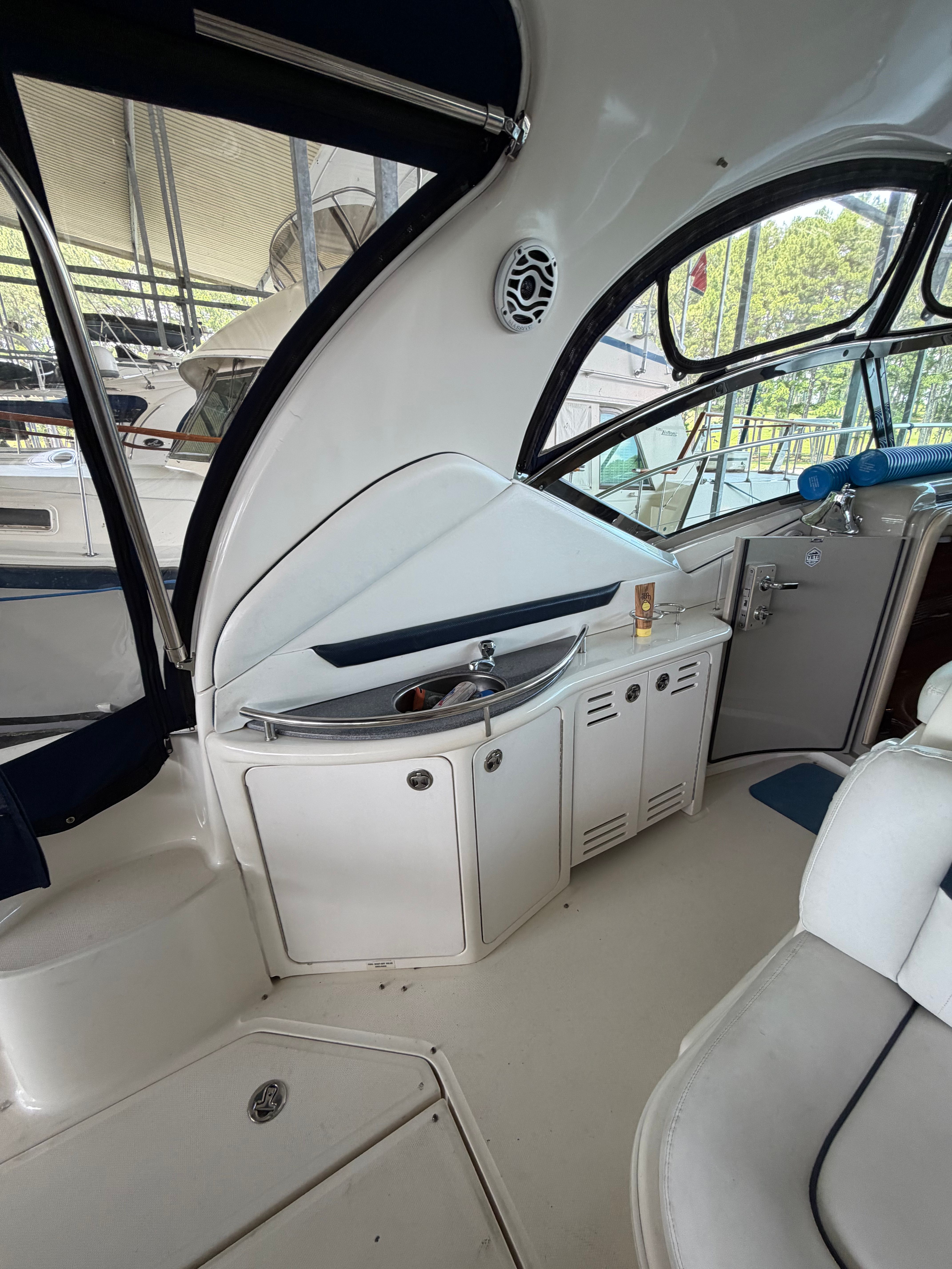 Interior of a 2005 Sea Ray 420DA with a sink and seating area.