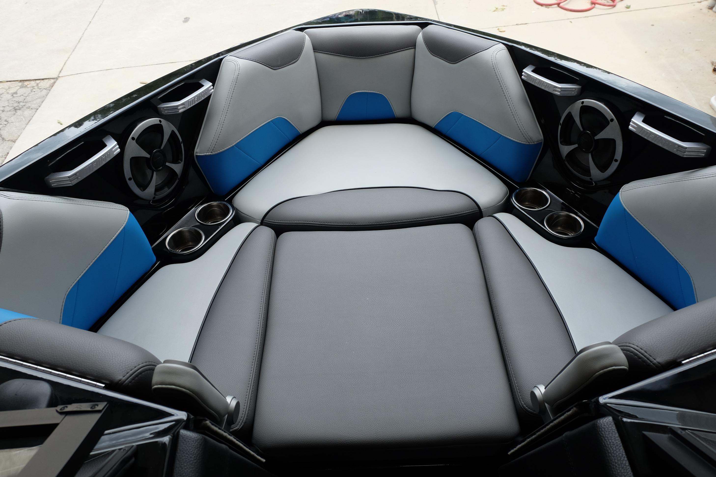 Interior seating of 2020 Malibu Wakesetter 23 LSV boat with cup holders and speakers.