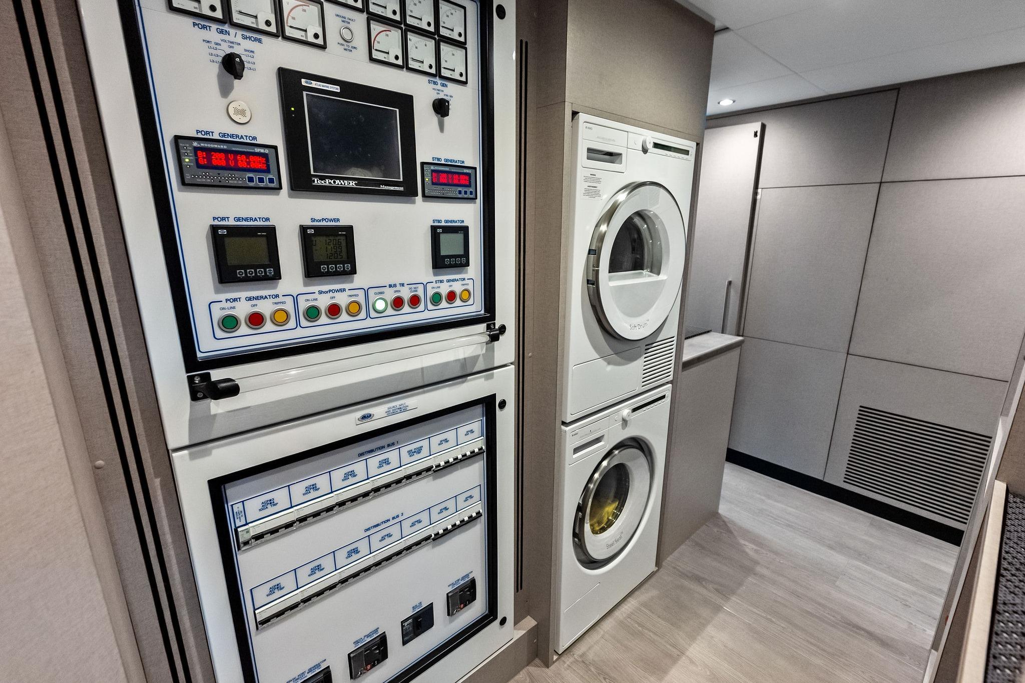 2024 Ocean Alexander 35 Revolution yacht interior with control panel and laundry appliances.