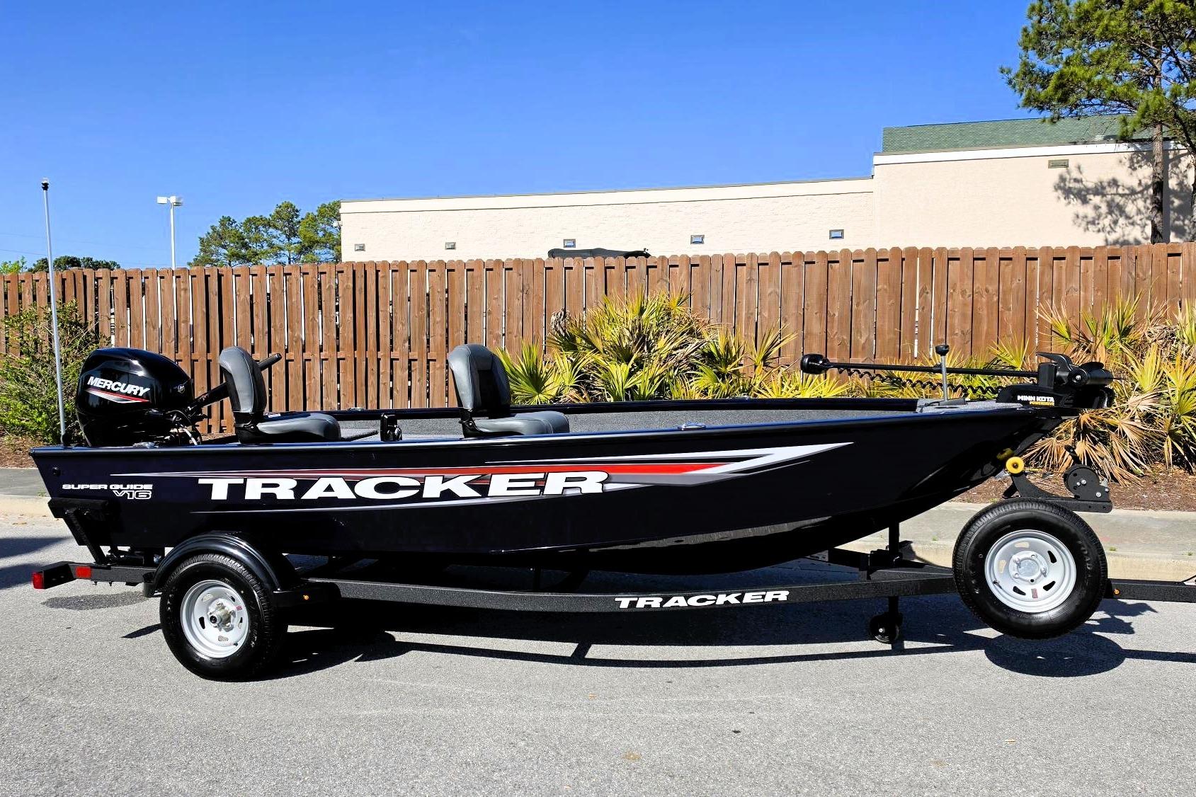 2026 Tracker Super Guide V-16 T boat on trailer, parked outdoors.