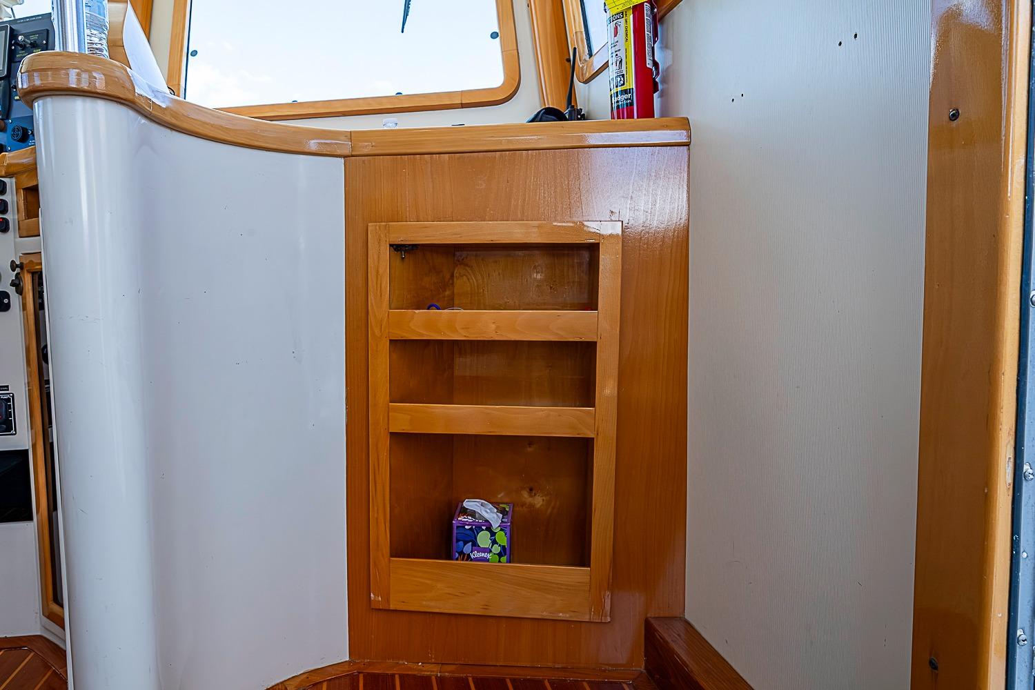 Interior of 2003 Magna Marine Nova Scotia 47 with wooden shelving and fire extinguisher.