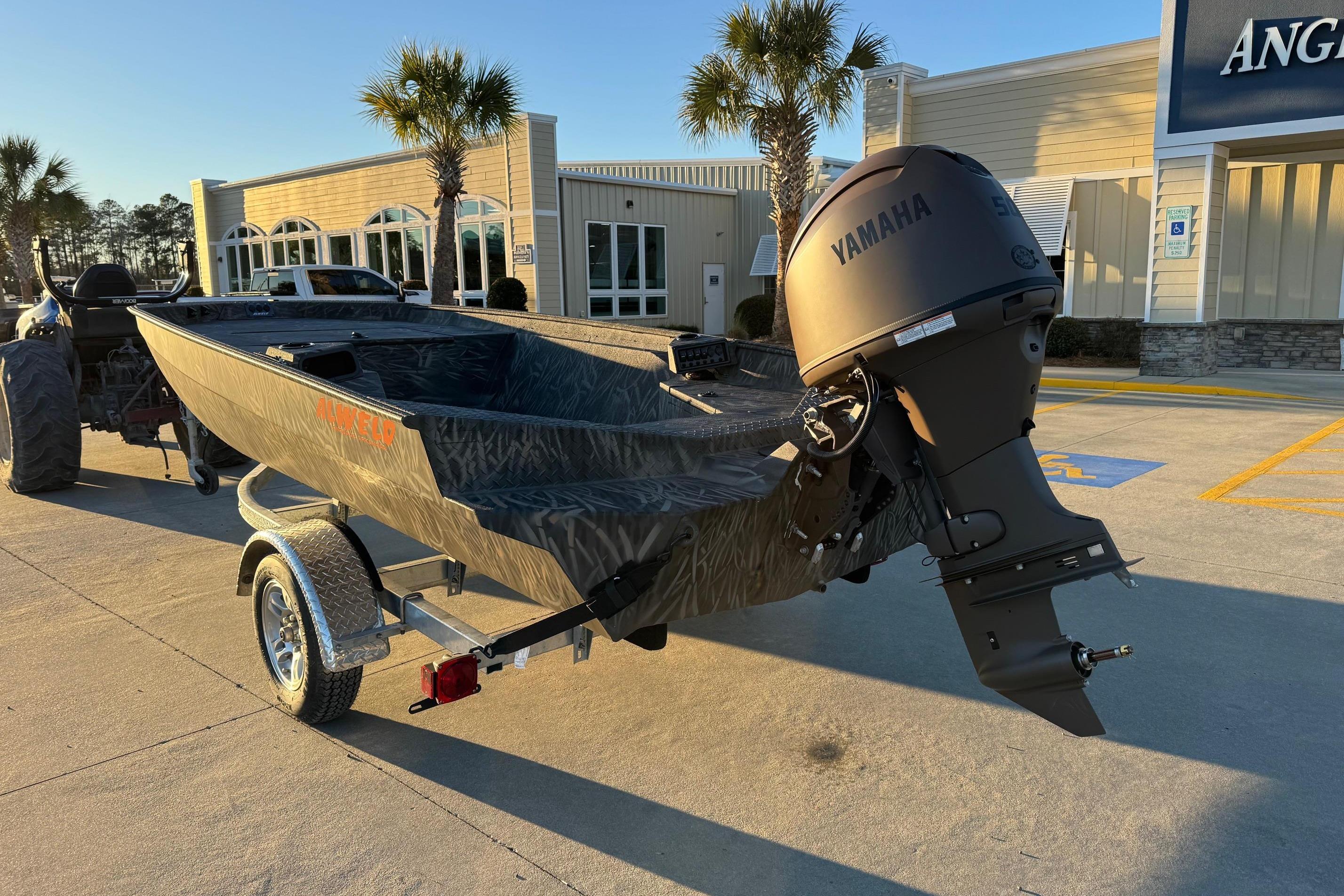 2026 Alweld 1652 Invader boat with Yamaha motor on trailer, parked outdoors.