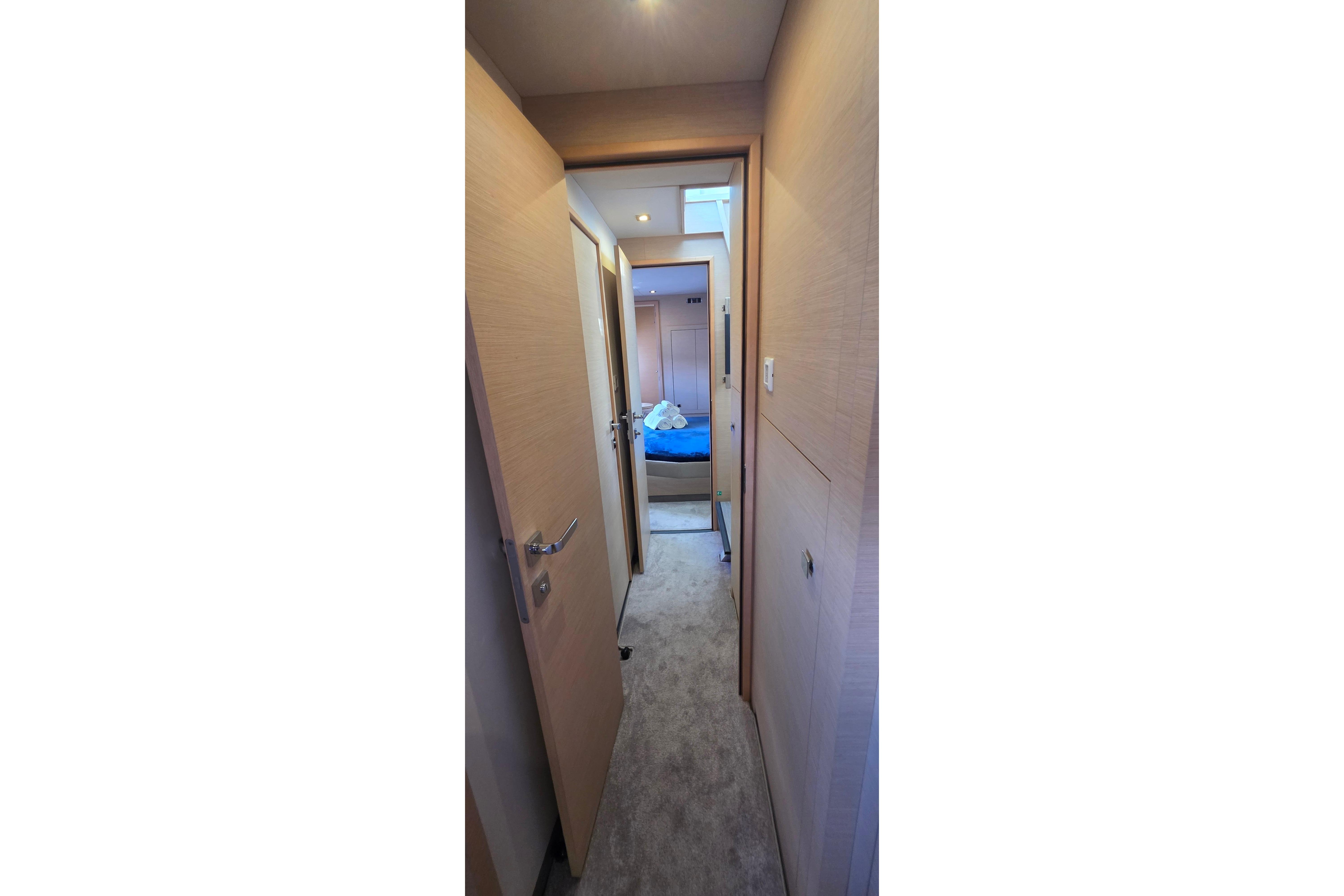 Hallway view inside 2018 Fountaine Pajot Motor Yacht 44, leading to a cozy cabin.
