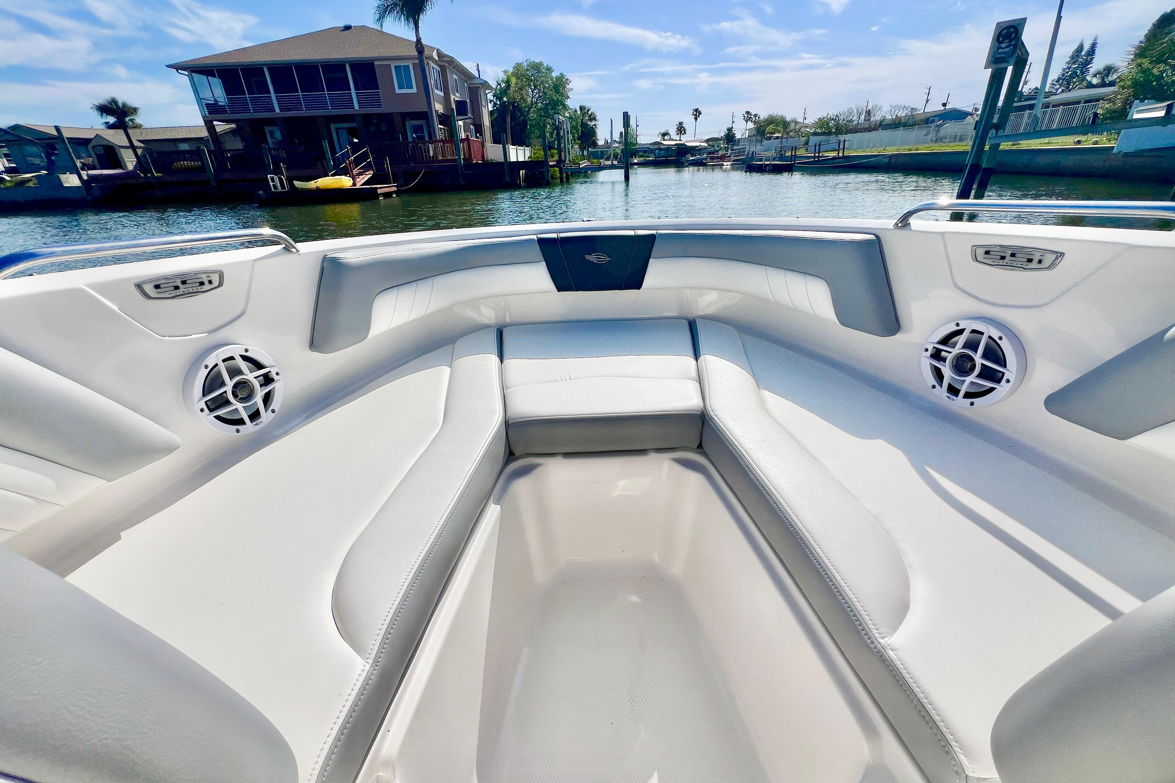 2023 Chaparral 21 SSi OB boat interior with white seating and waterfront view.