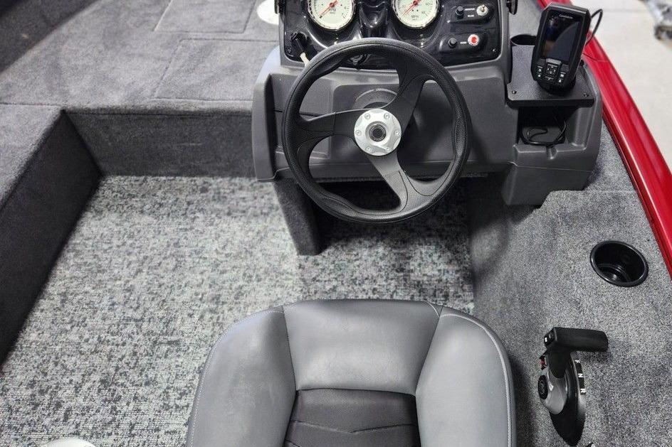 Interior of 2026 Tracker Super Guide V-16 SC boat with steering wheel and controls.