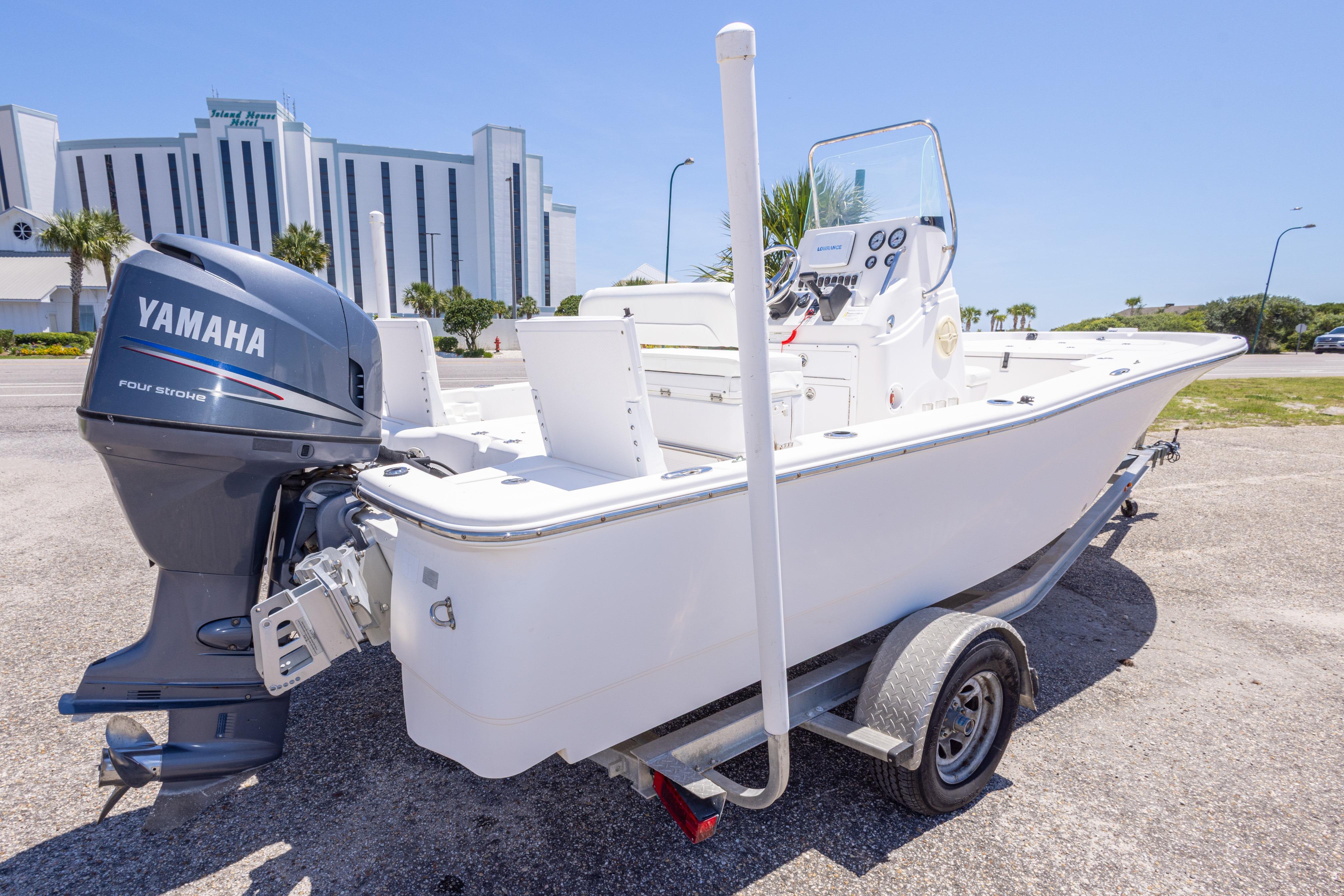 2011 Sea Fox 200XT boat with Yamaha engine on trailer, parked near a hotel.