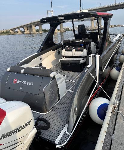 2017 Mystic Powerboats M4200 docked by a bridge.