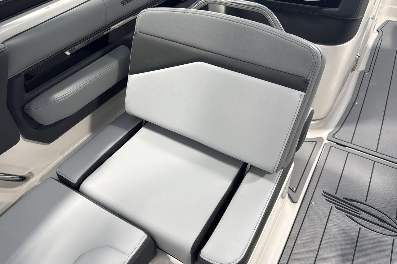 The image shows a gray and black seat in a modern boat.