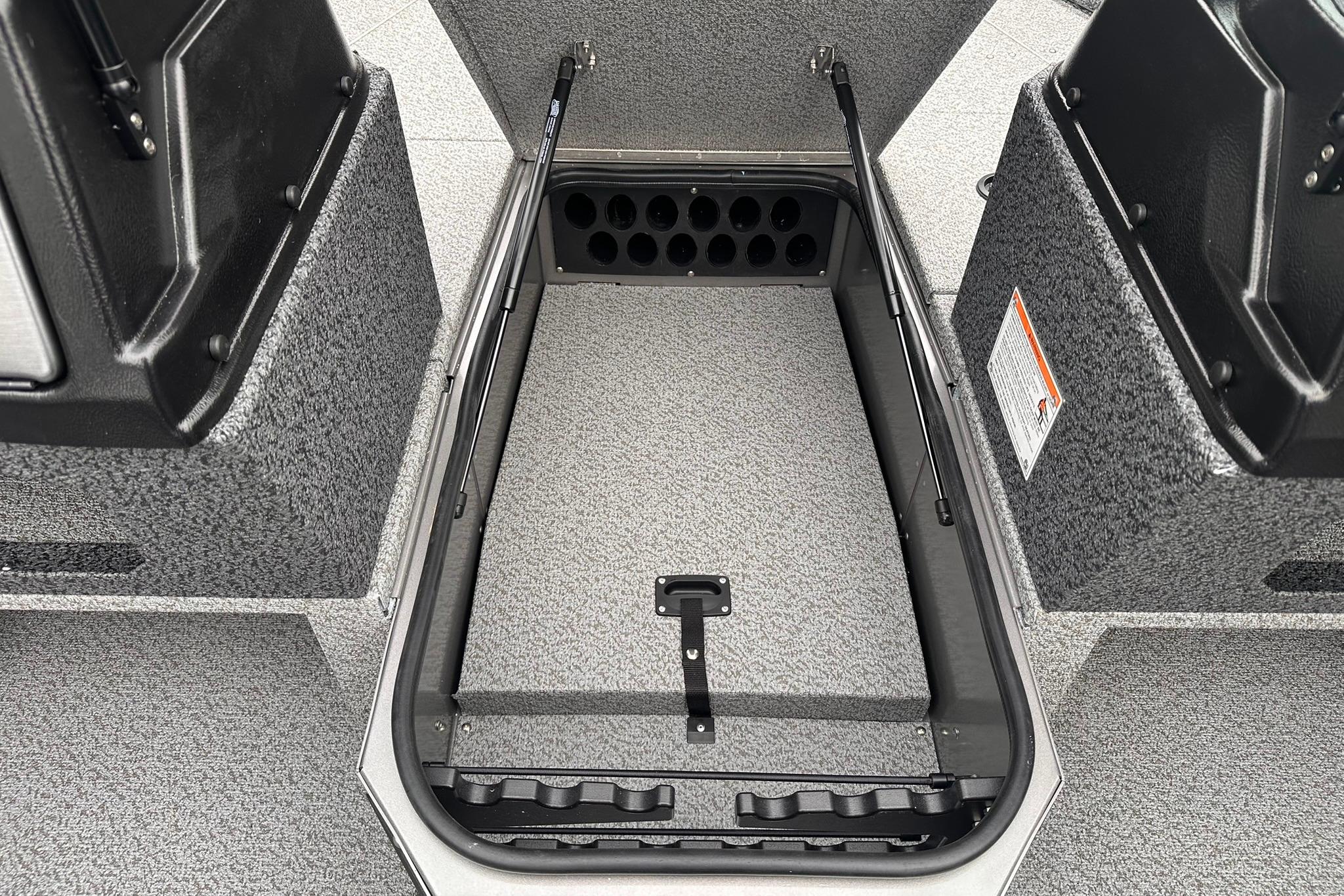 2026 Lund 1775 Impact XS Sport boat interior storage compartment, open and empty.