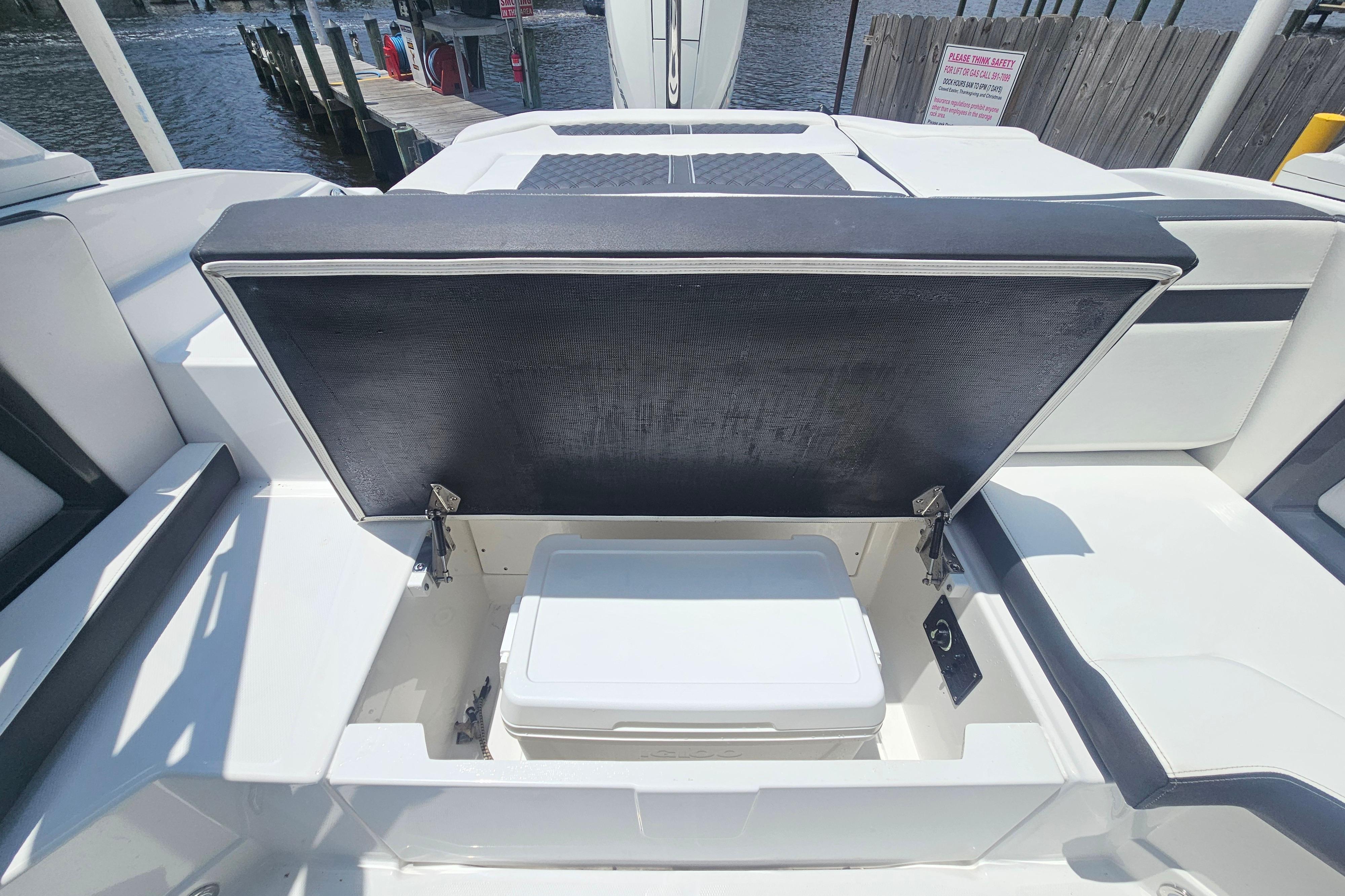 2024 Monterey 215SS Super Sport boat with open storage compartment and cooler.