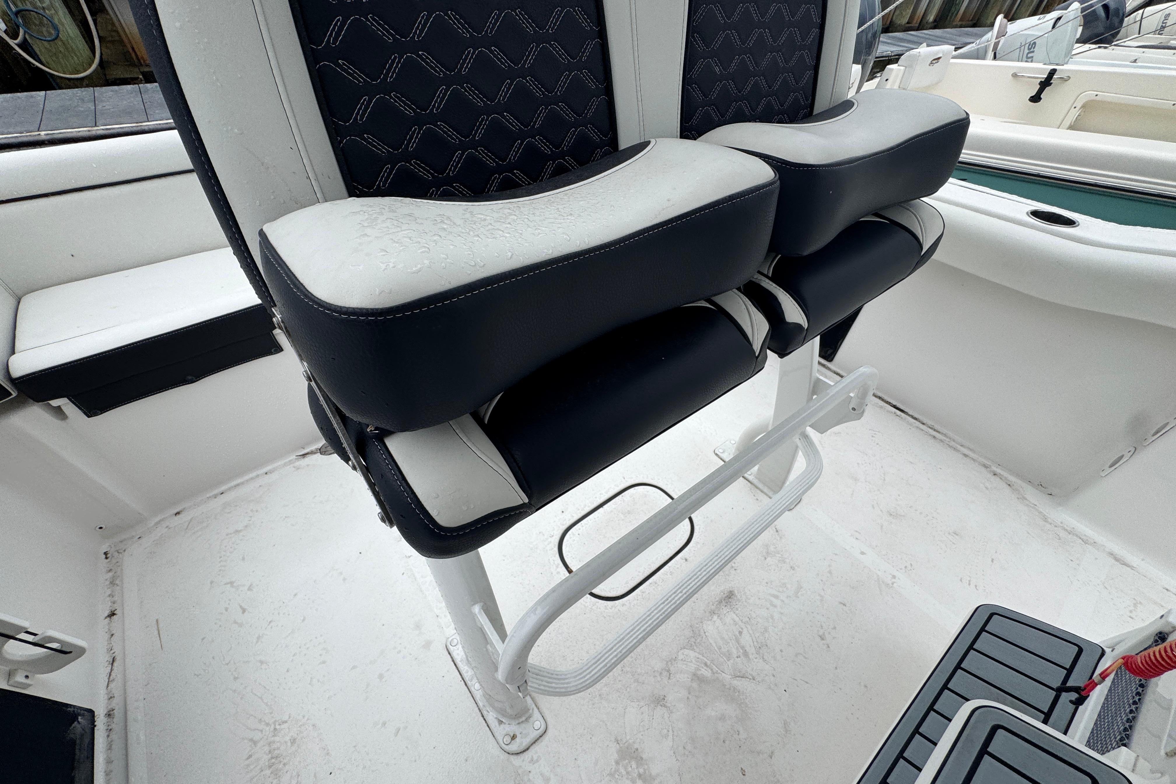 2022 Tidewater 232 SS boat interior with dual cushioned seats and sleek design.