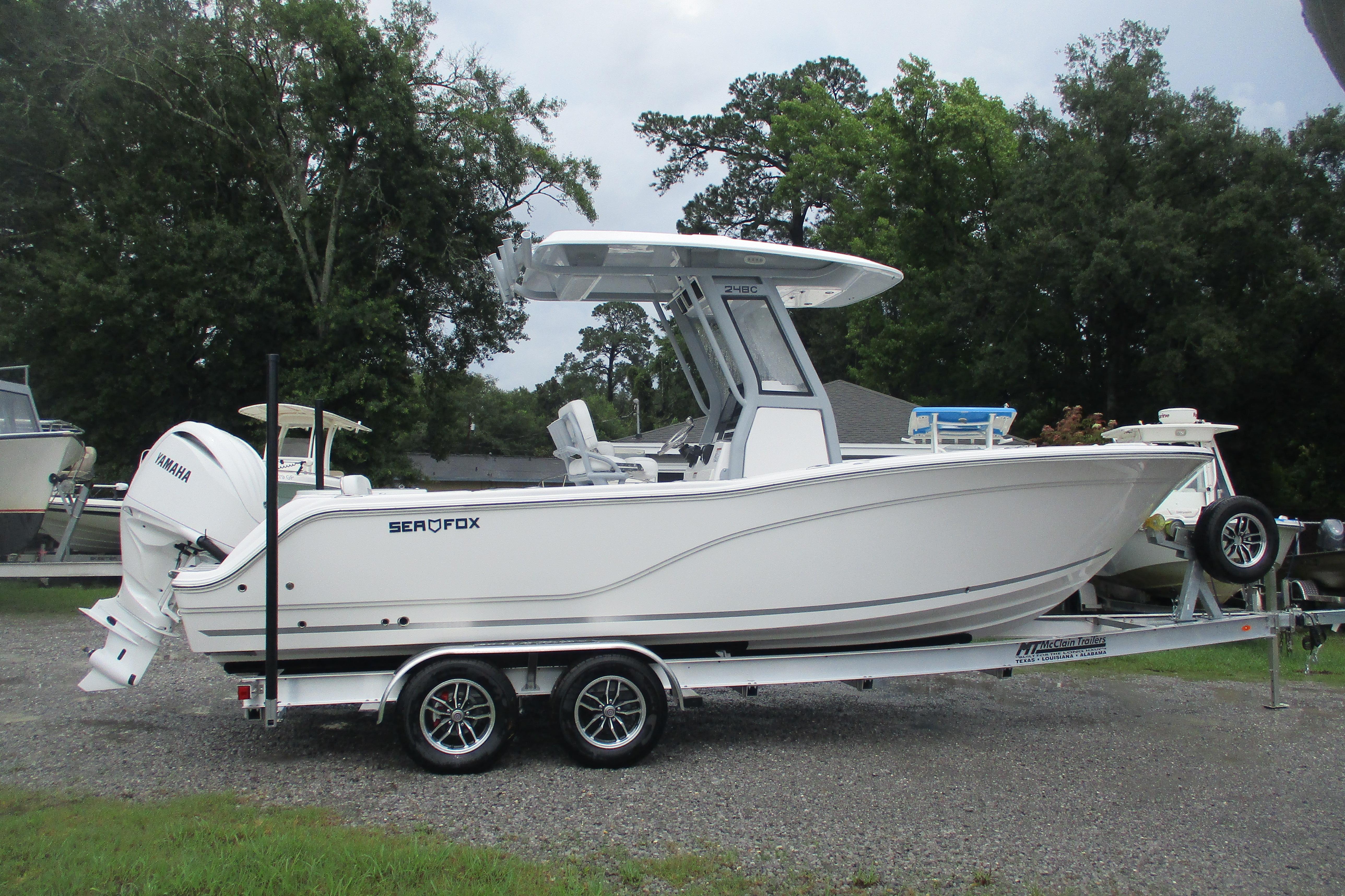 2026 Sea Fox 248 Commander boat on trailer, side view, outdoors.