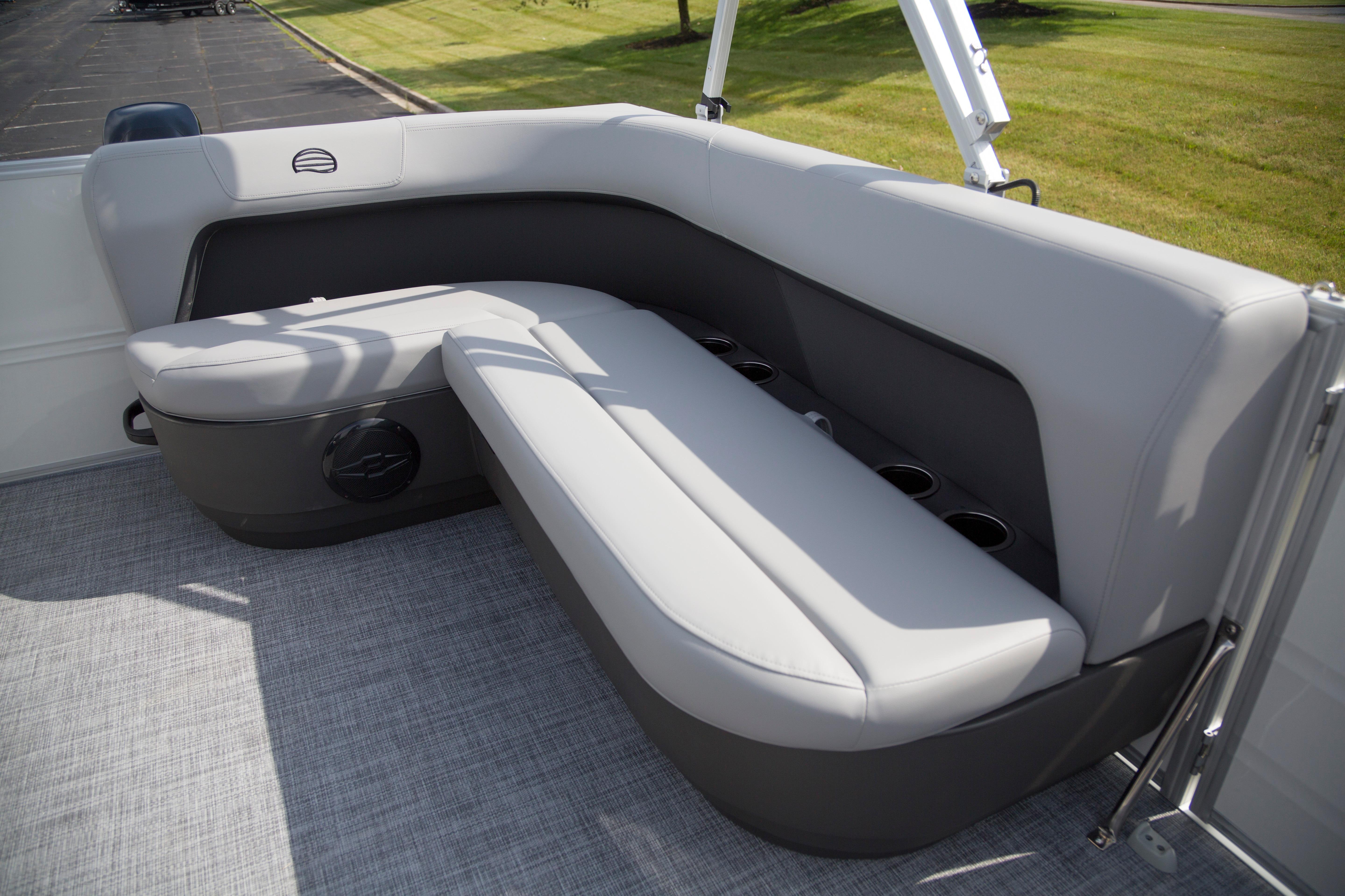 2026 Sun Tracker Party Barge 16 DLX interior seating with cup holders and gray upholstery.