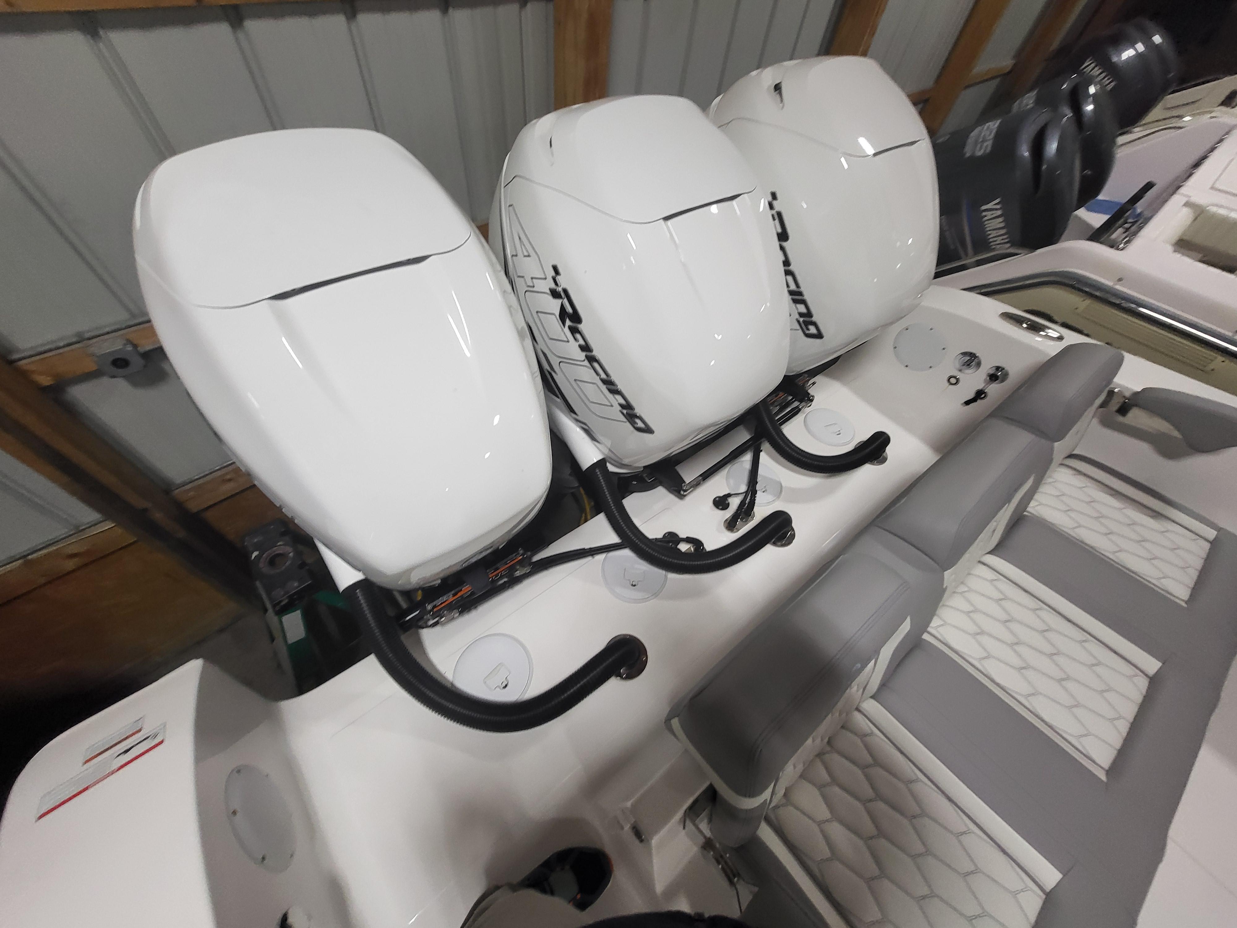 2022 Fountain 38 SC boat with triple outboard engines in a storage facility.