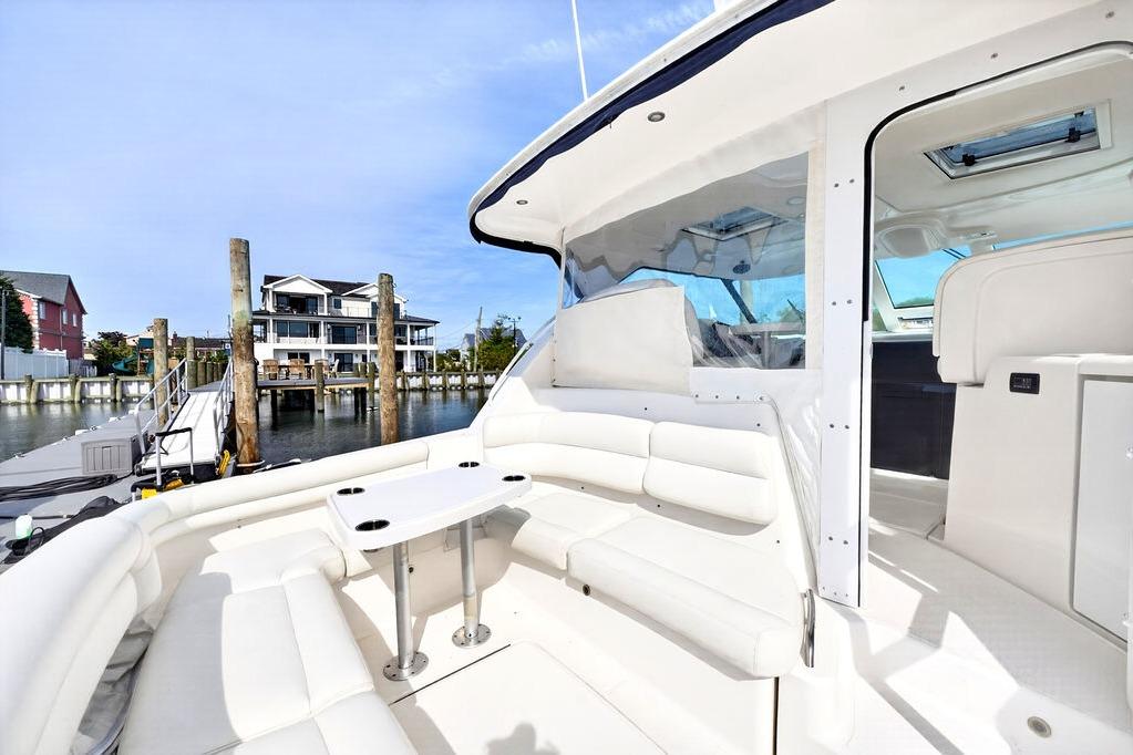 2006 Tiara Yachts 4300 Sovran with white seating, docked near waterfront homes.