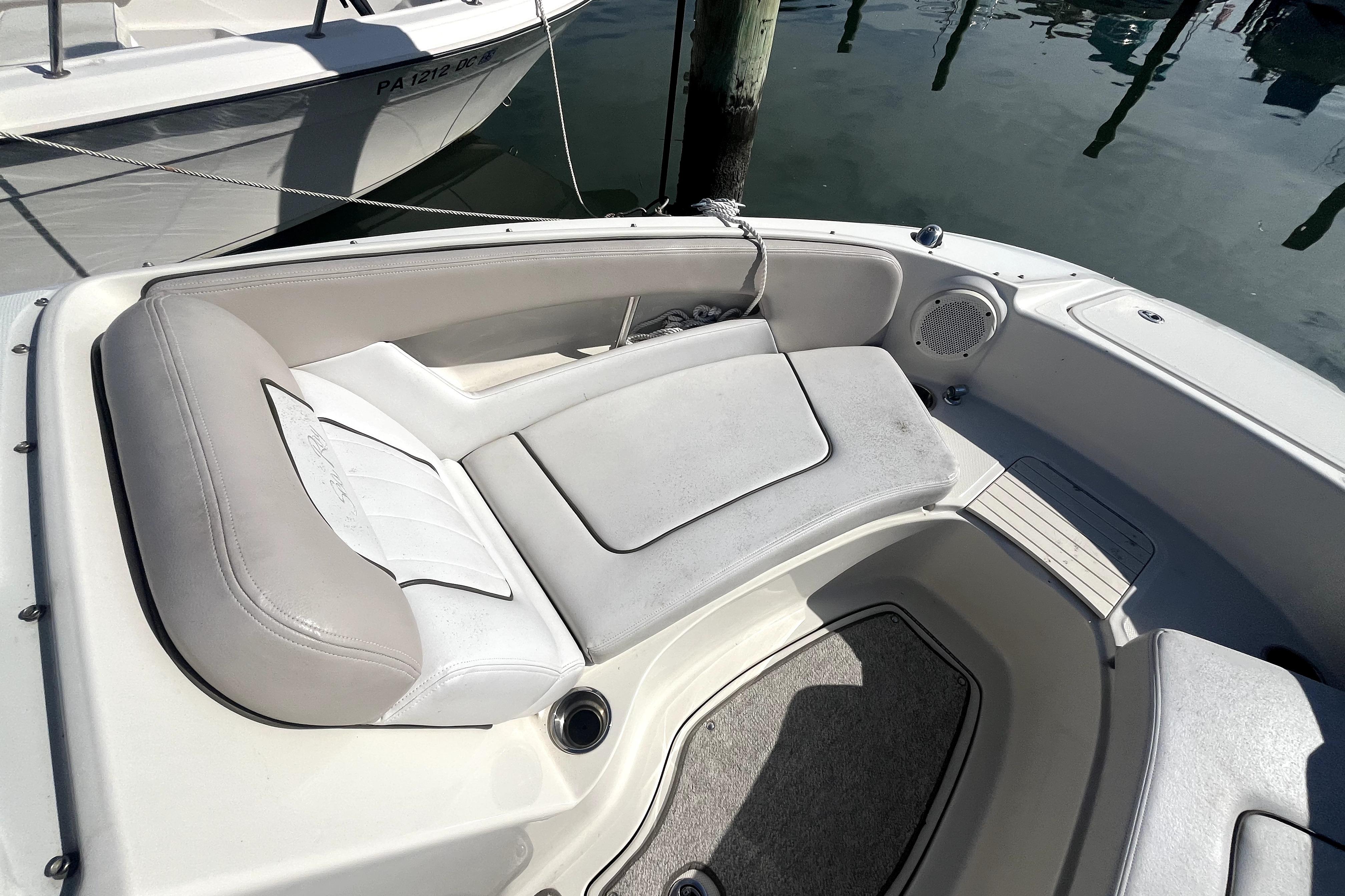 2010 Sea Ray 220 Sundeck boat interior with cushioned seating and speaker.