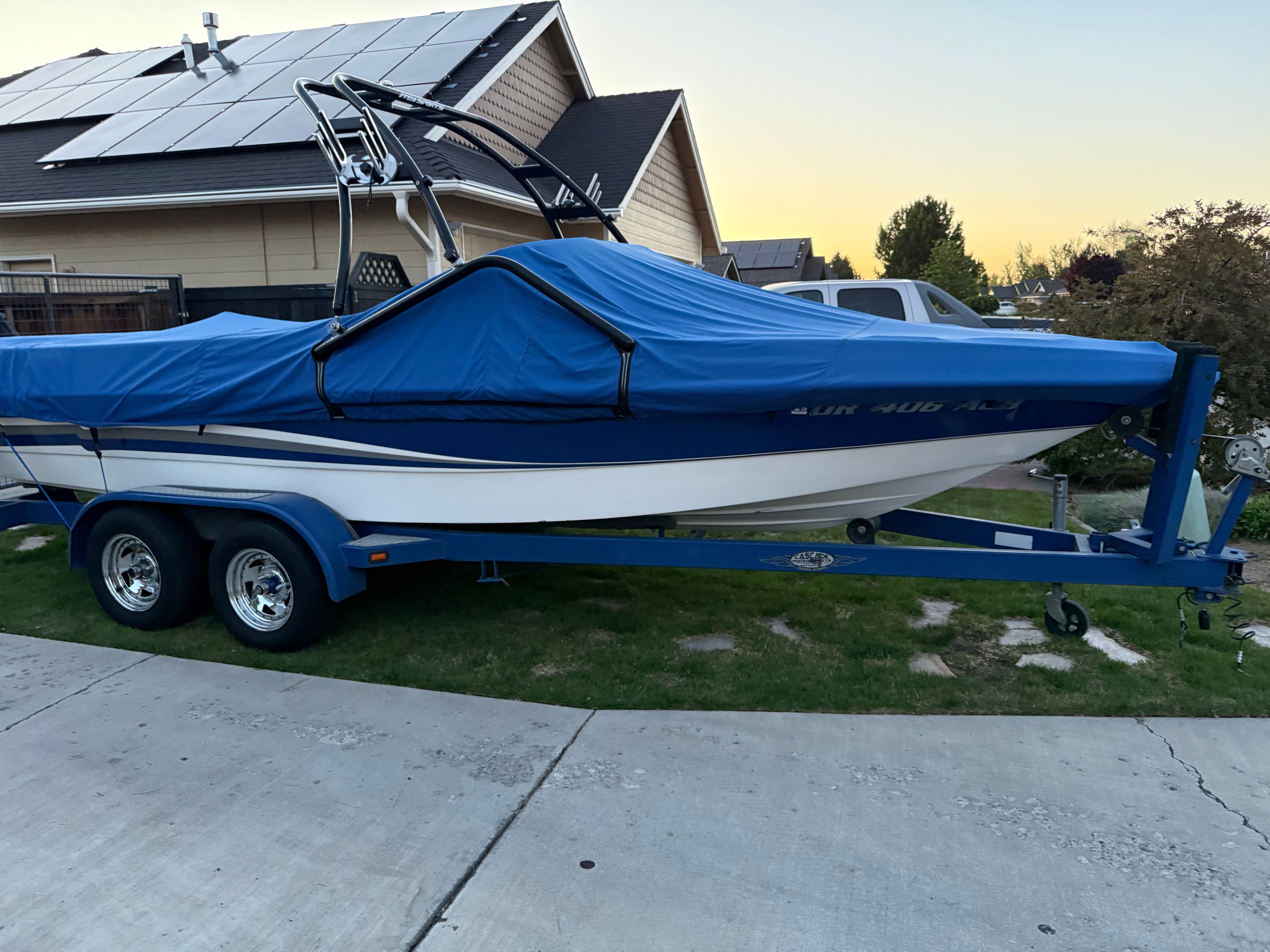 2004 MB Sports 220 boat with blue cover on trailer.