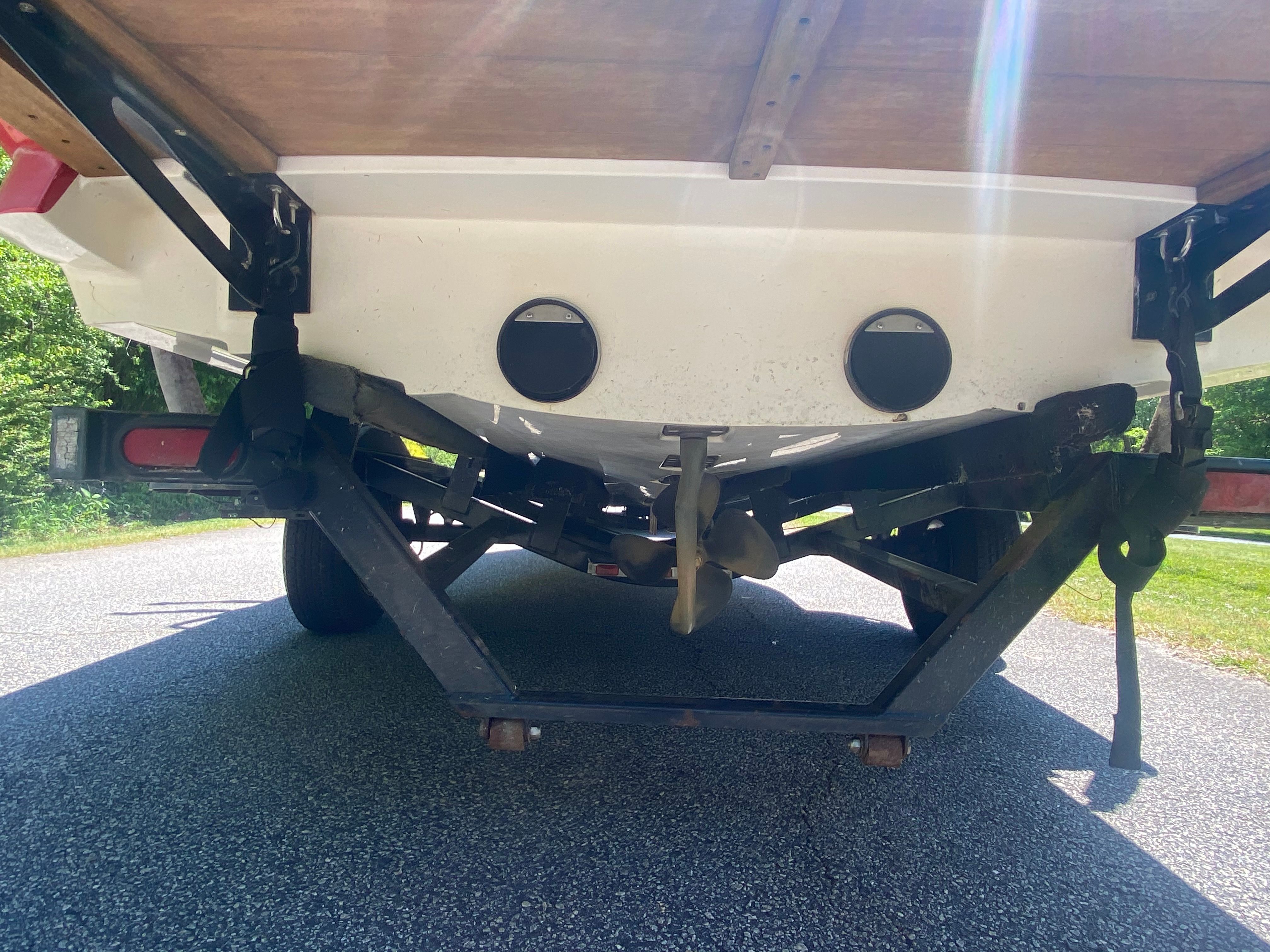 Rear view of a MasterCraft X-9 boat on a trailer, with visible propeller.