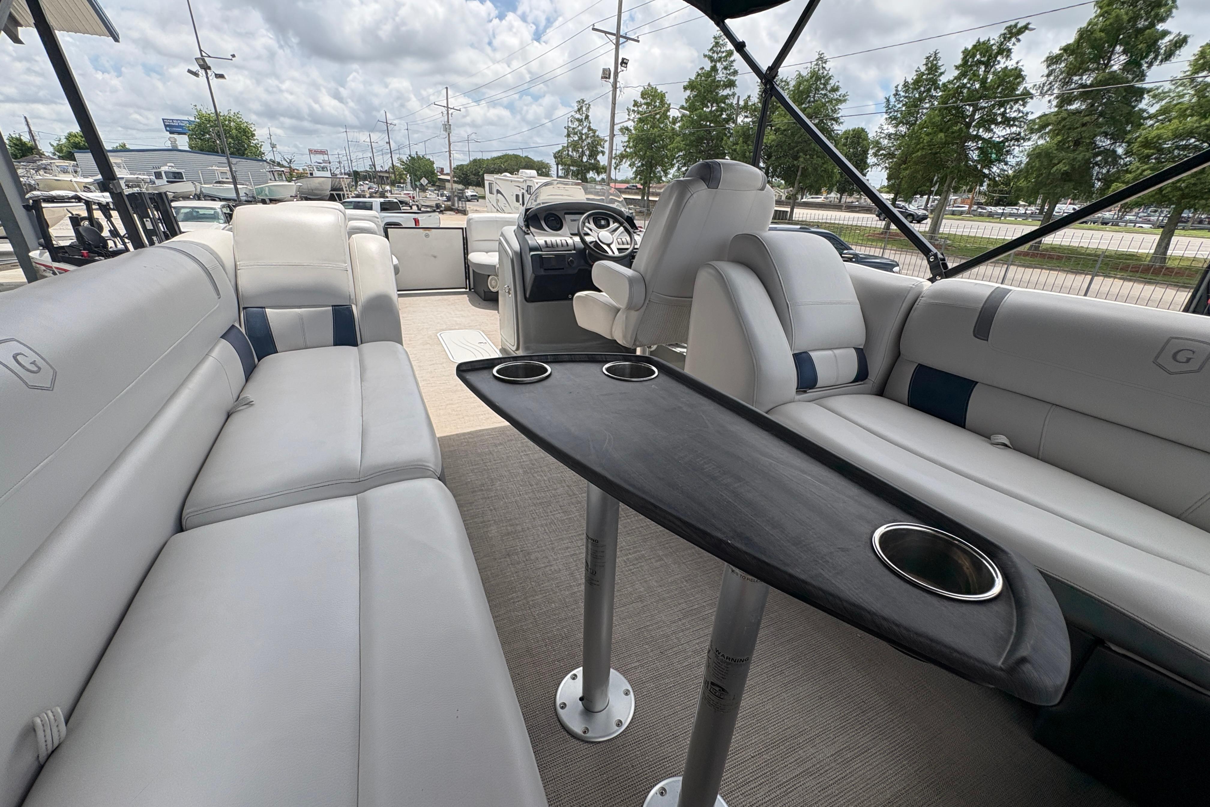 2019 Godfrey Aqua Patio interior with plush seating and sleek table design.