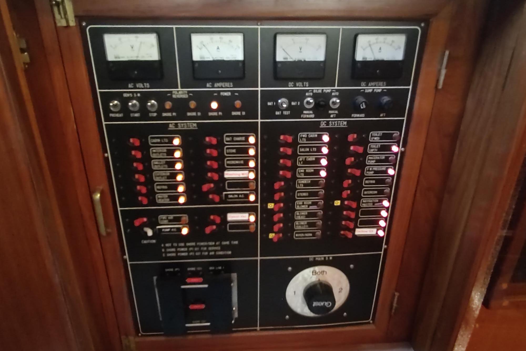 Electrical control panel on a 1989 Hyatt Double Cabin Motoryacht, featuring AC and DC systems.