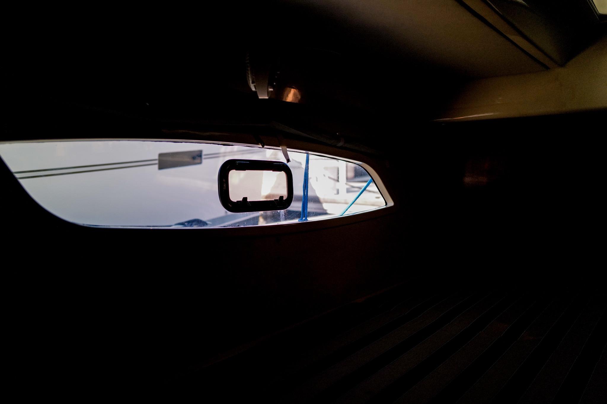 Interior view of a 2012 Leopard 44 yacht, showcasing a window with exterior reflections.