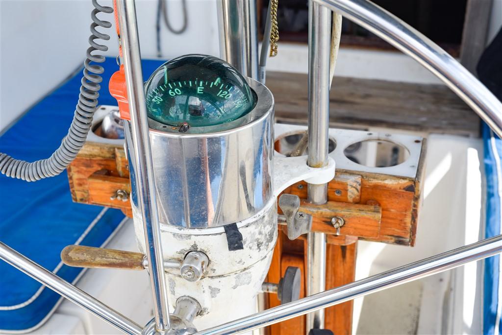 1982 Morgan 383 sailboat helm with compass and steering wheel.