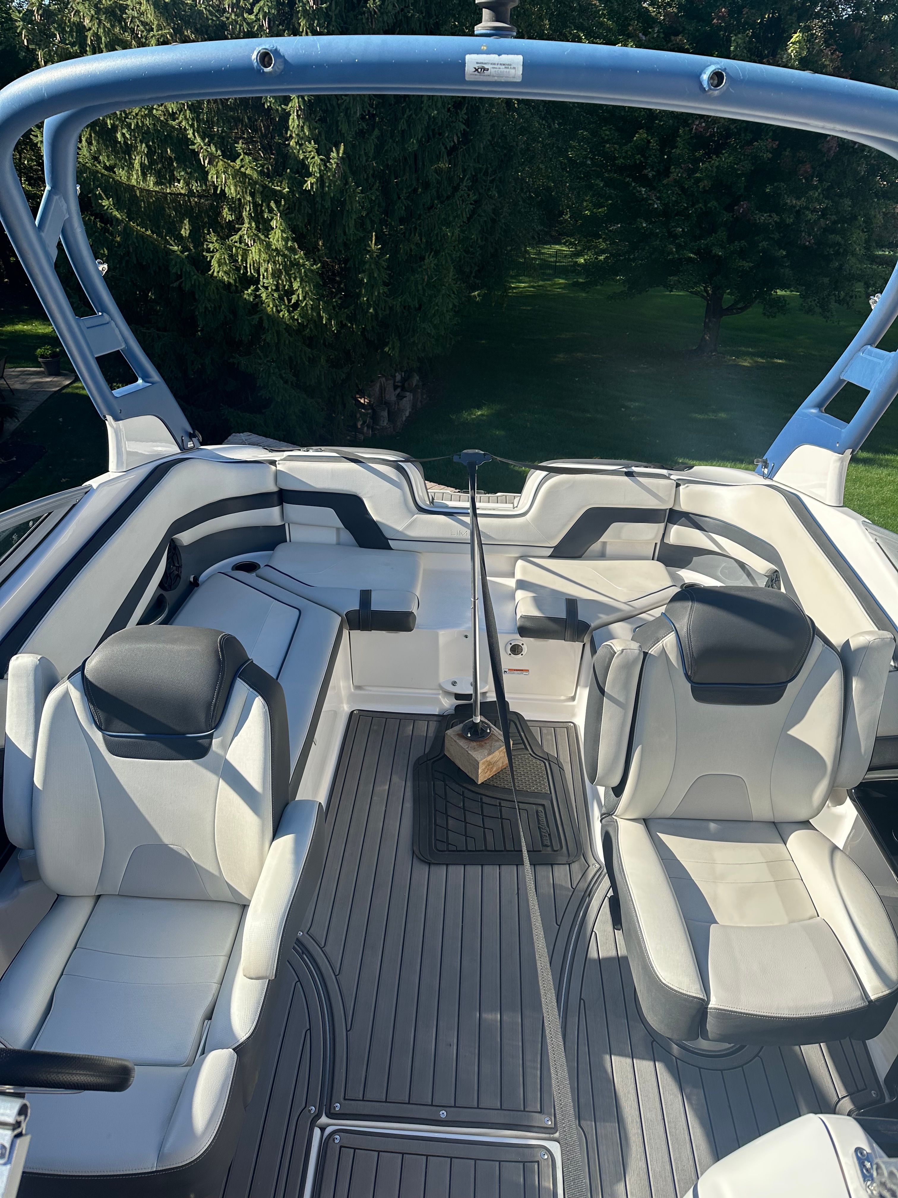 The image shows the cockpit of a 2018 Yamaha 242 Limited S boat with sleek seating.