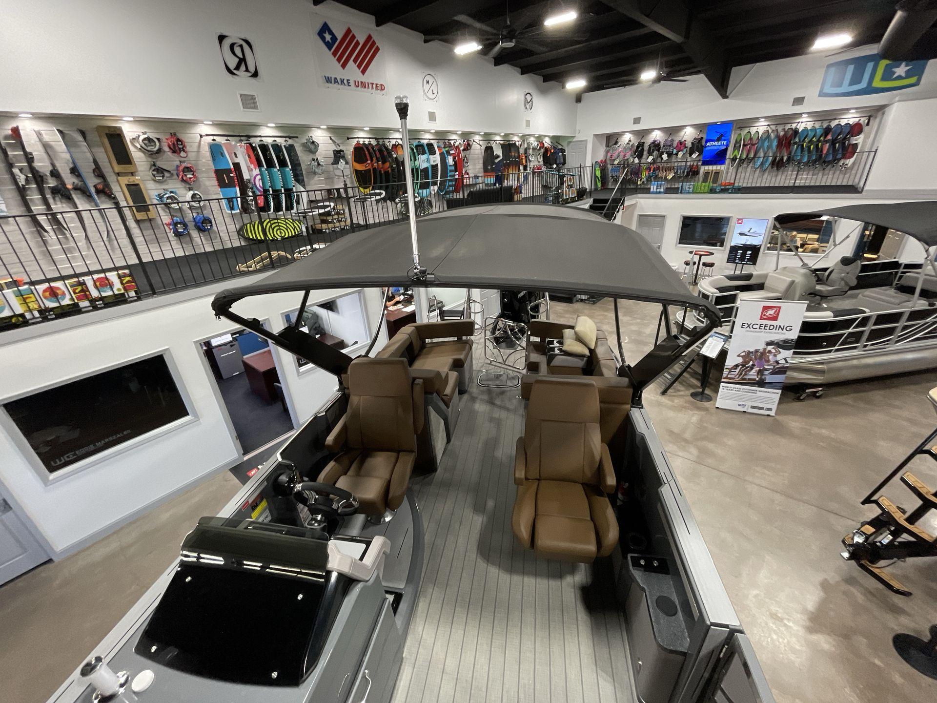 2025 Balise Horizon 26C boat displayed in a showroom with water sports equipment.