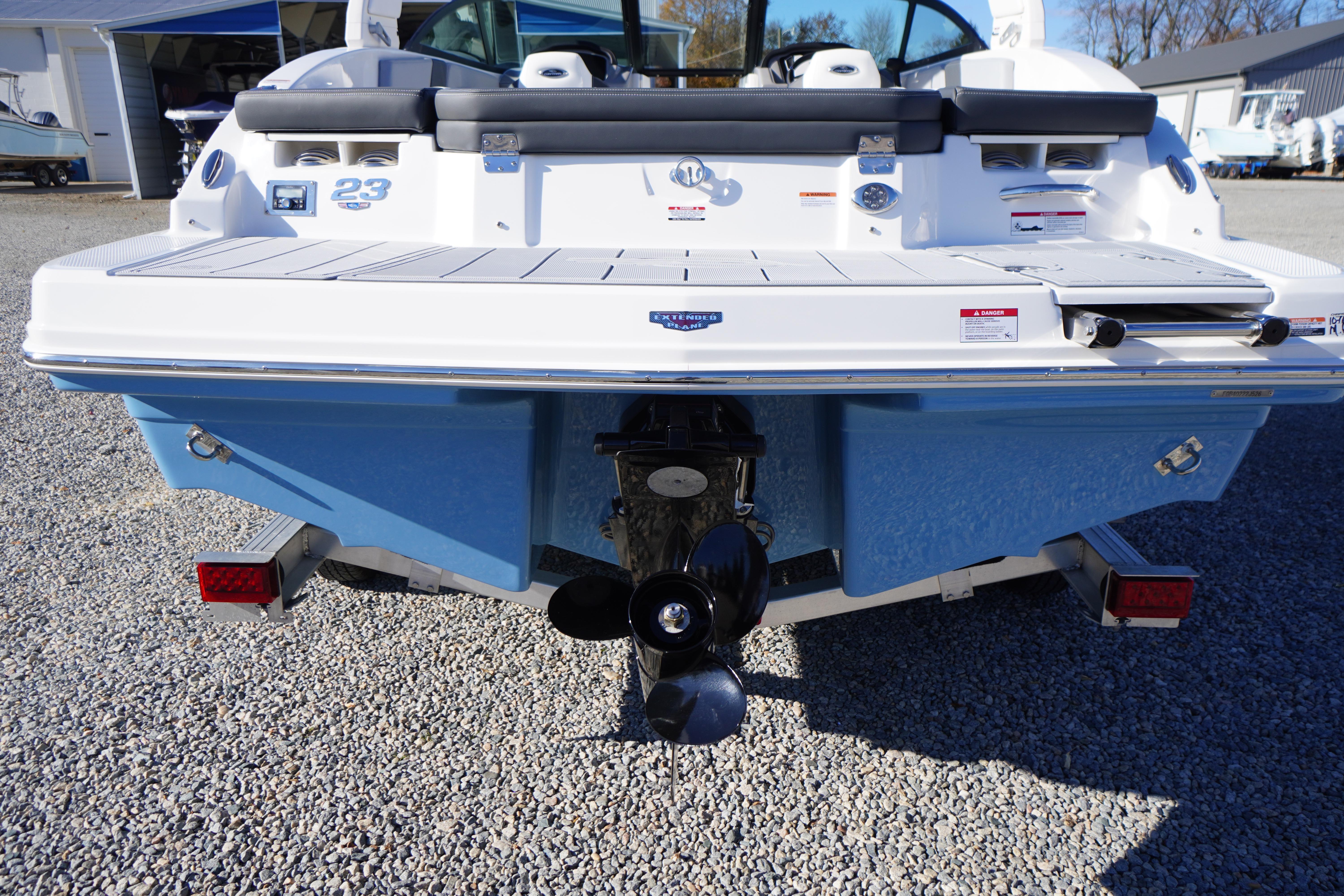 Rear view of 2026 Chaparral 23 SSi boat on trailer, showcasing propeller and swim platform.