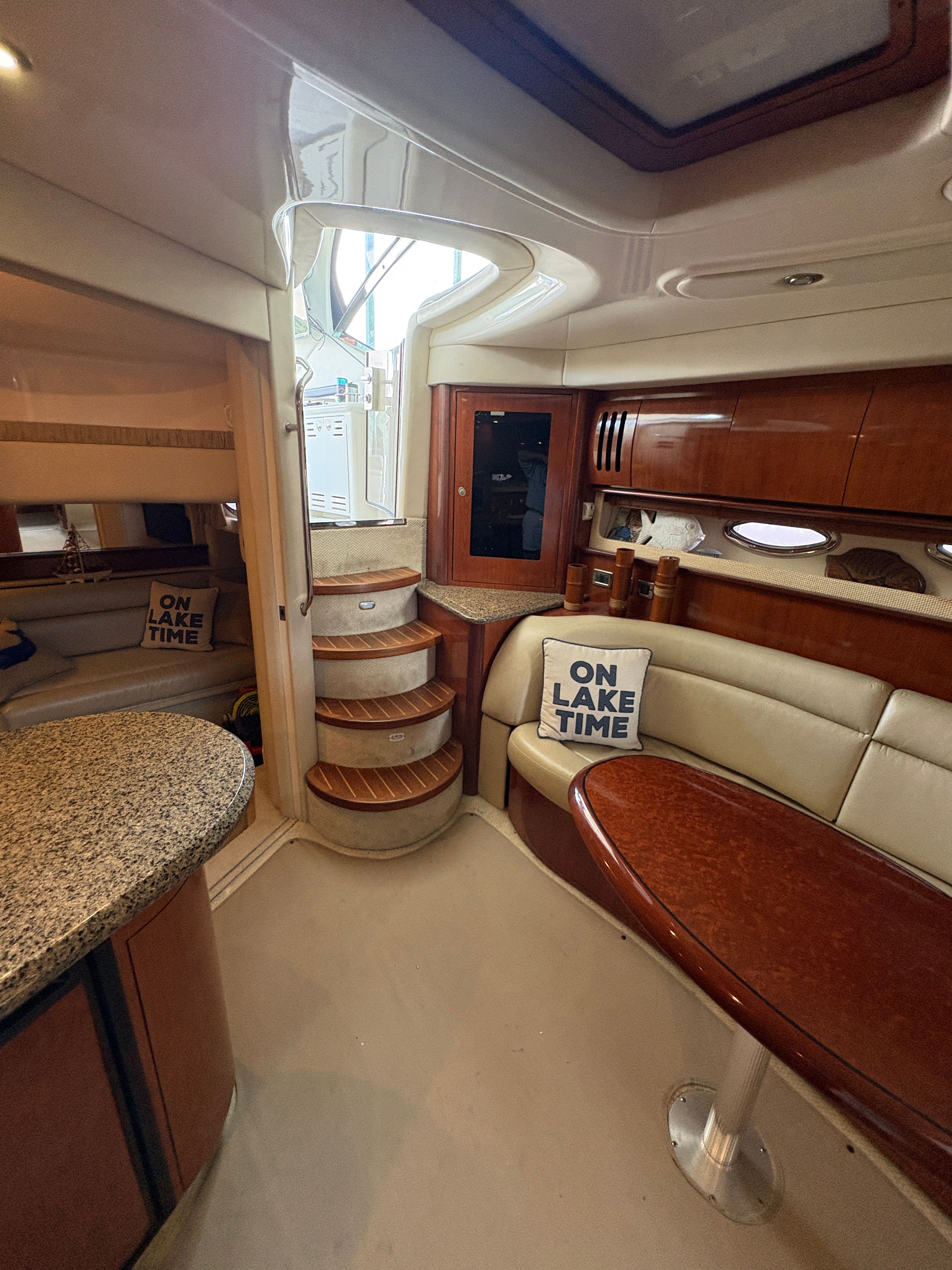 Interior of a 2005 Sea Ray 420 Sundancer yacht with cozy seating area.