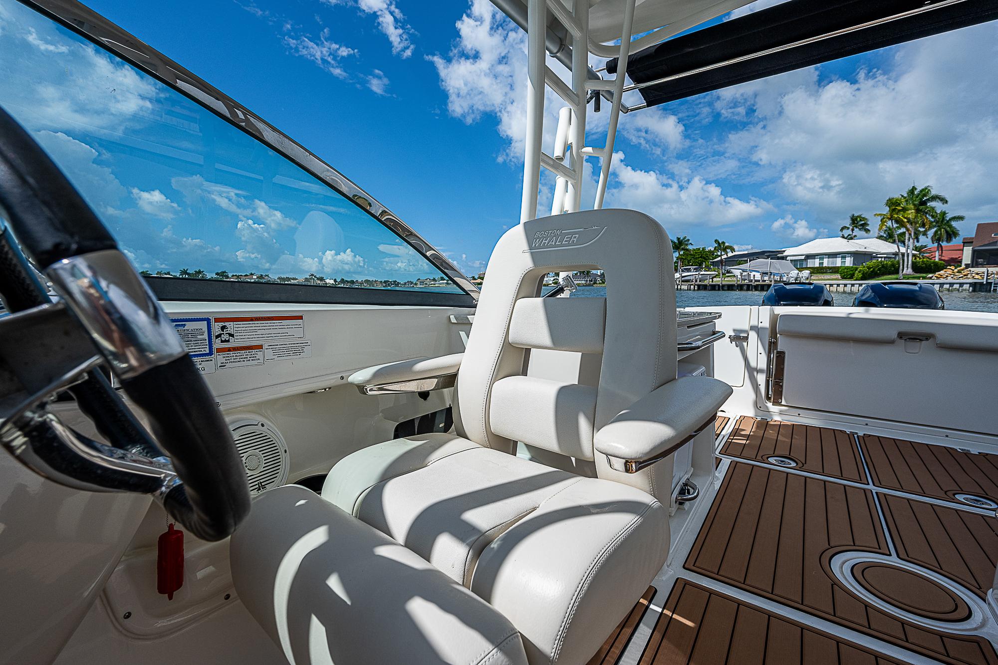2018 Boston Whaler 270 Vantage boat interior with white seating and wooden deck.